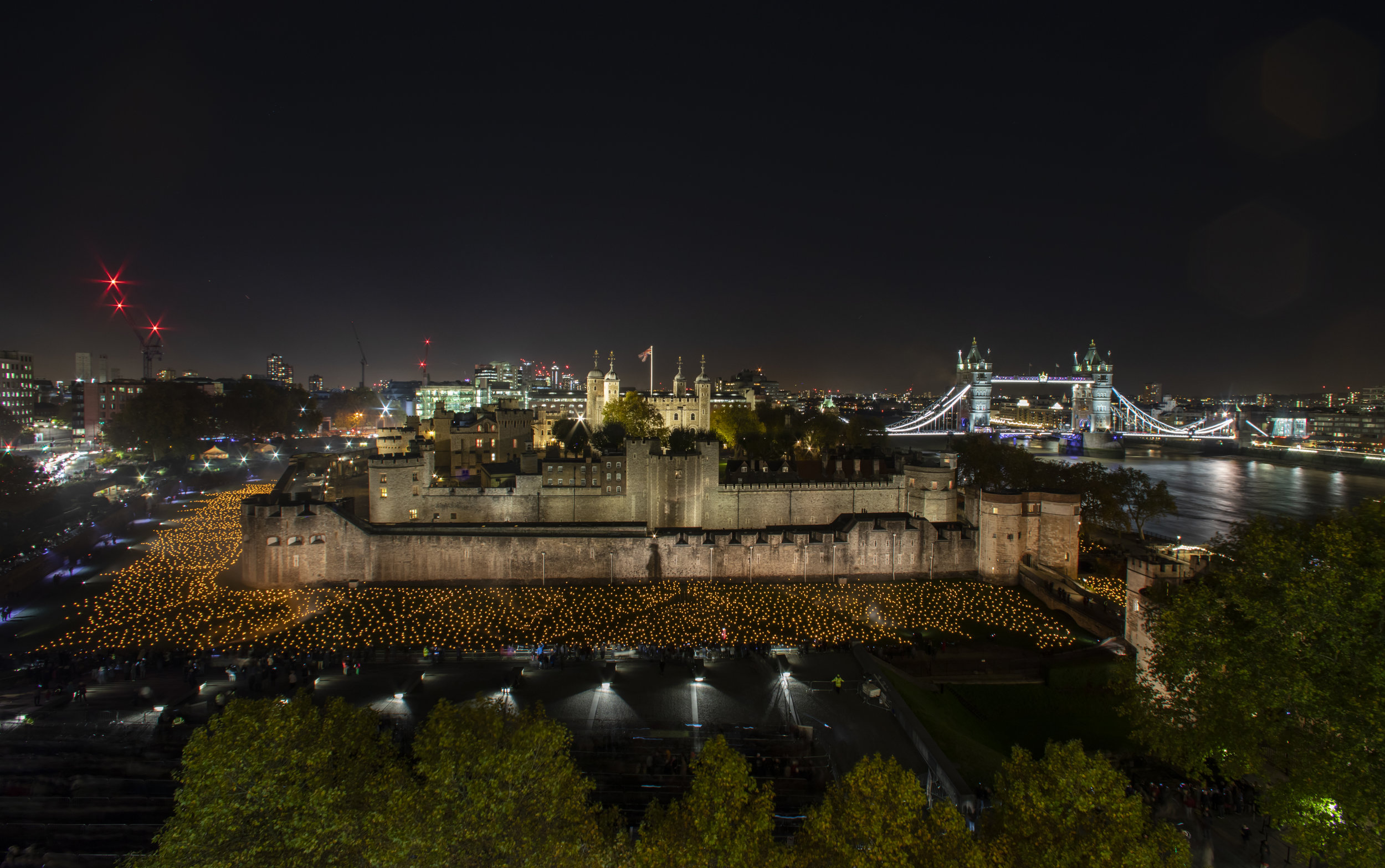  'Beyond the Deepening Shadow: The Tower Remembers'  
An installation at The Tower of London. Which consists of thousands of individual flames illuminate the moat of The Tower of London to mark 100 year since the first World War ended.
Photo by Andre
