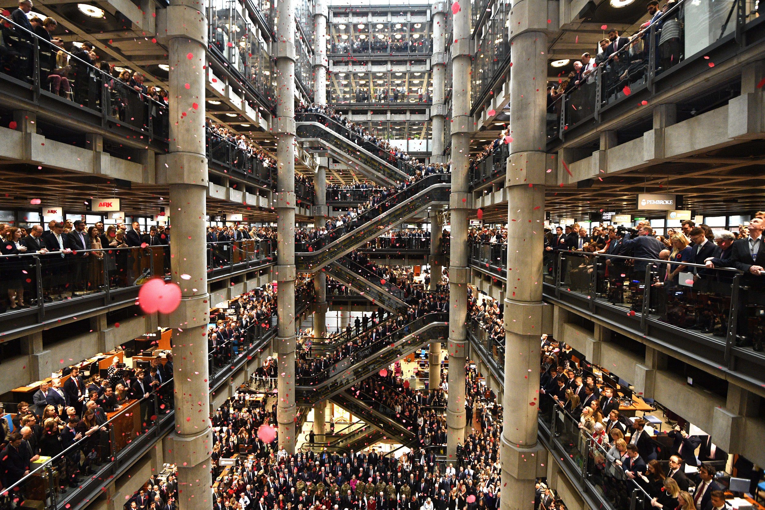  Staff line the atrium as poppies fall during an Armistice Commemoration Service at Lloyds of London. The 11th of November 2018 marks 100 years since the end of the First World War.


Photo by Neil Hall, 09 November 2018
 