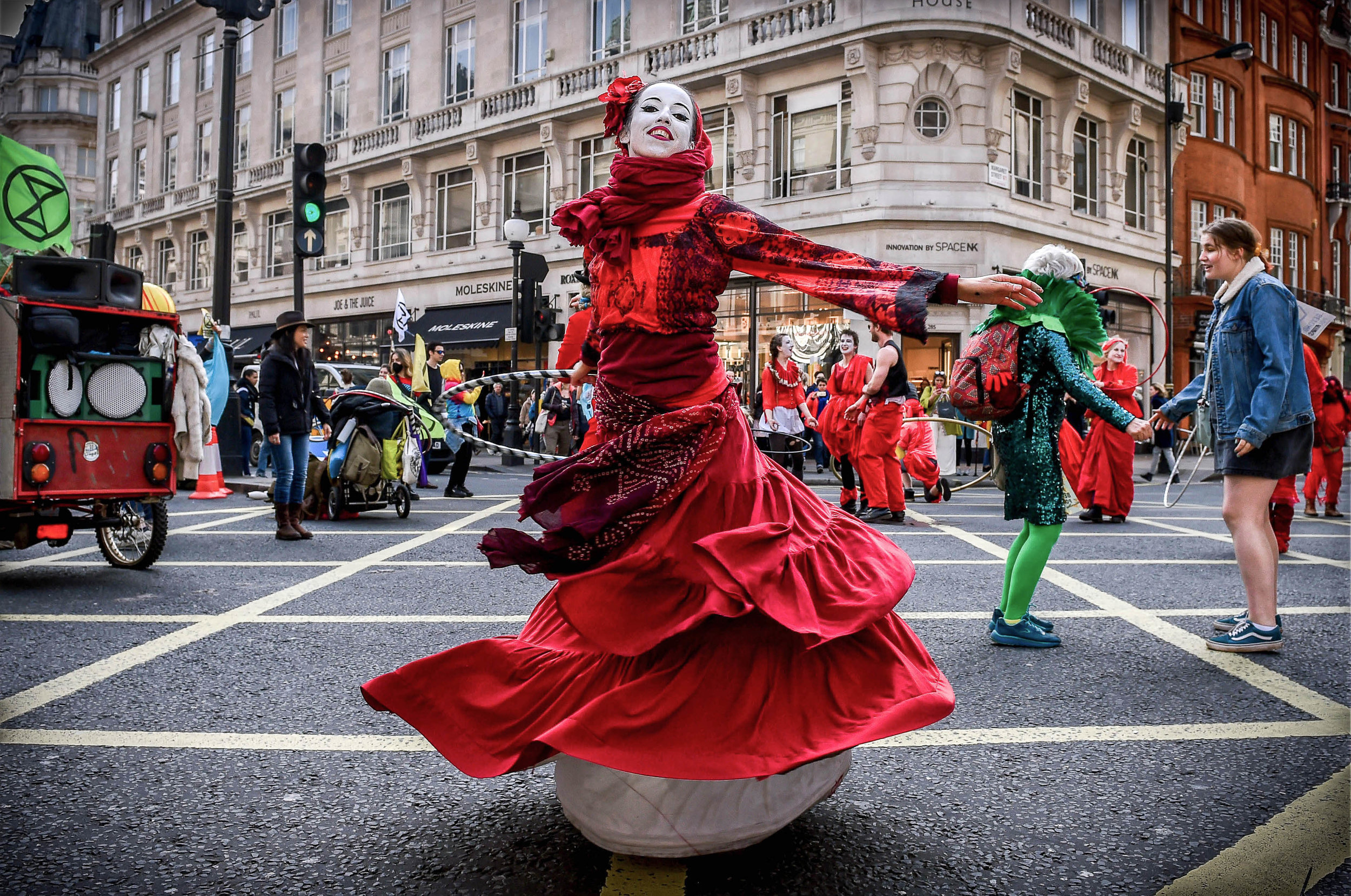  An activist in a red dress dances as Extinction Rebellion block Oxford Circus. The protesters are planning a 'Shut Down' of London in the hope that the disruption will force the government to act on climate change.
Photo by Pete Maclaine, 15 April 2