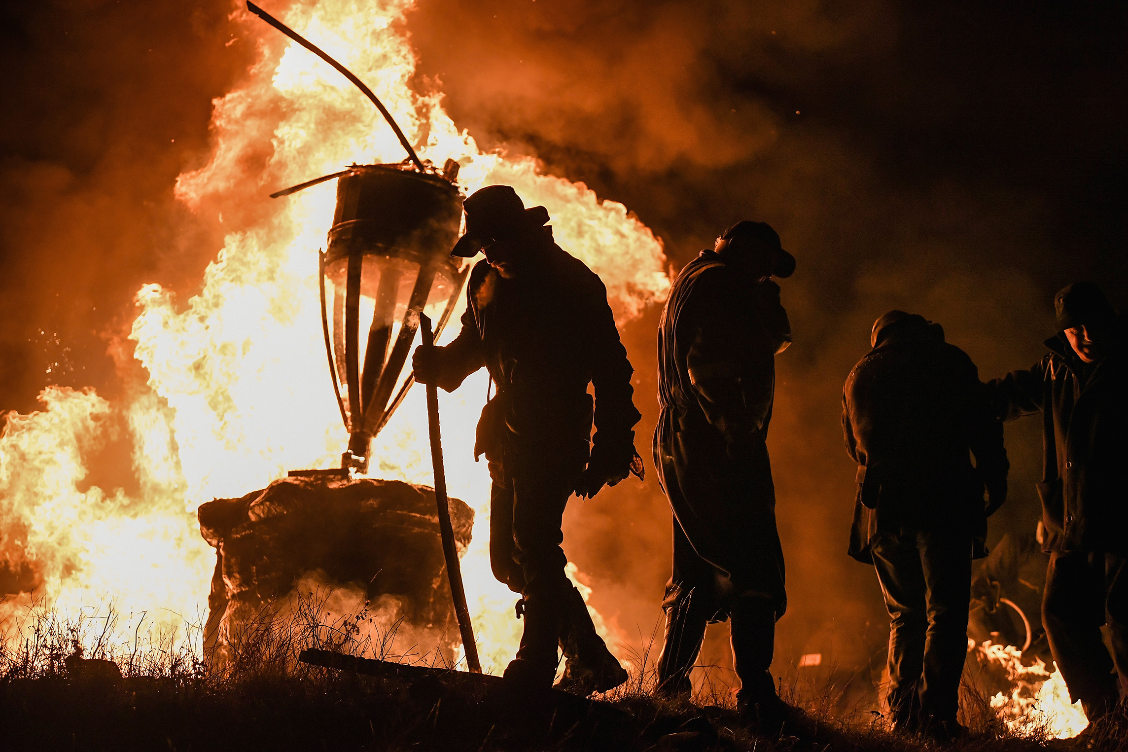  The Clavie, a burning barrel packed with tar soaked sticks fixed on the top of a pole, is surrounded by people at the Doorie Hill on January 11, 2018 in Burghead, Scotland.
Photo by Jeff J Mitchell, 11 January 2018
 