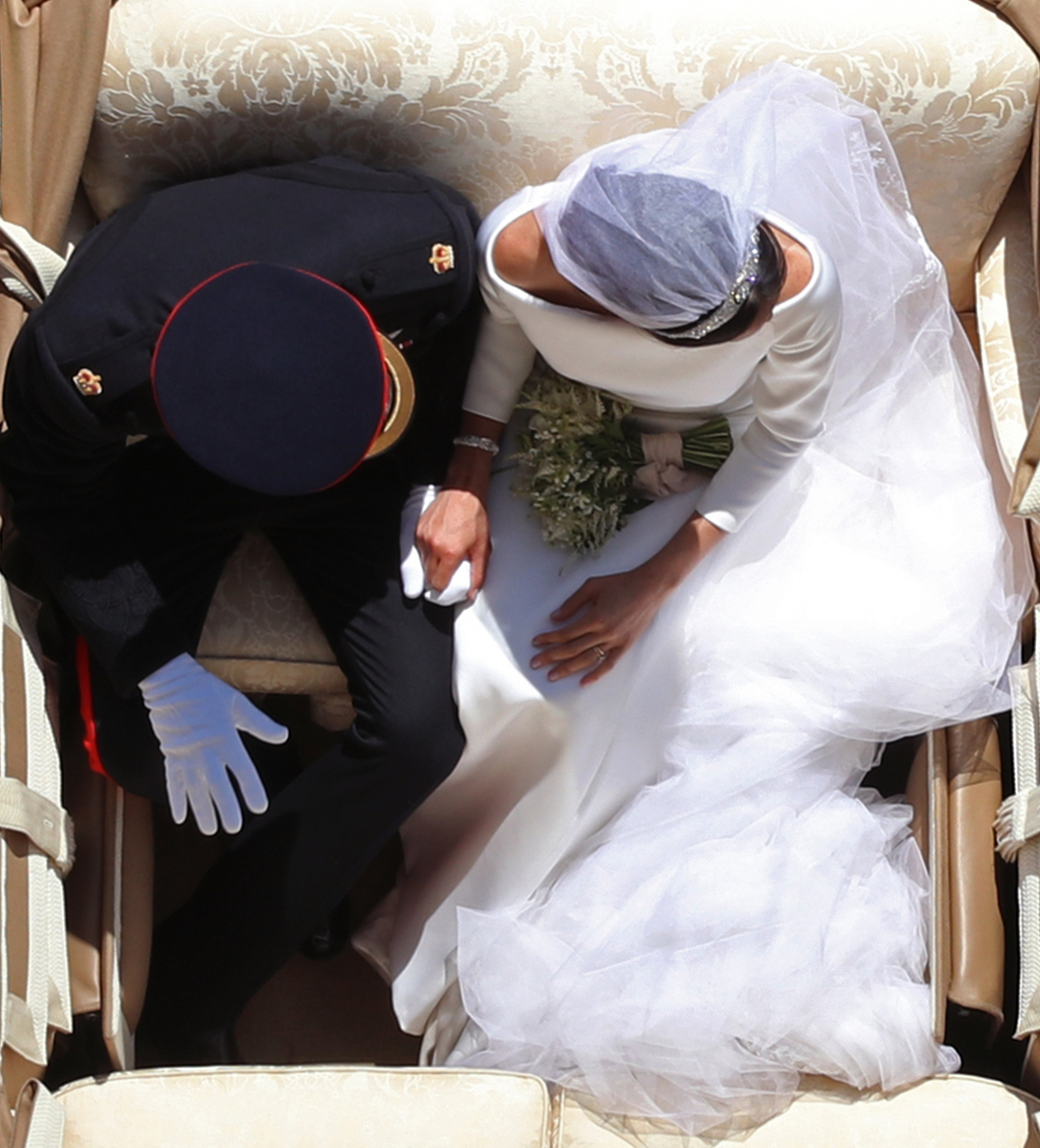  Prince Harry and Meghan Markle ride in an Ascot Landau beneath the King George IV Gateway of Windsor Castle, after their wedding in St George's Chapel in Windsor Castle.
Photo by Yui Mok, 19 May 2018
 