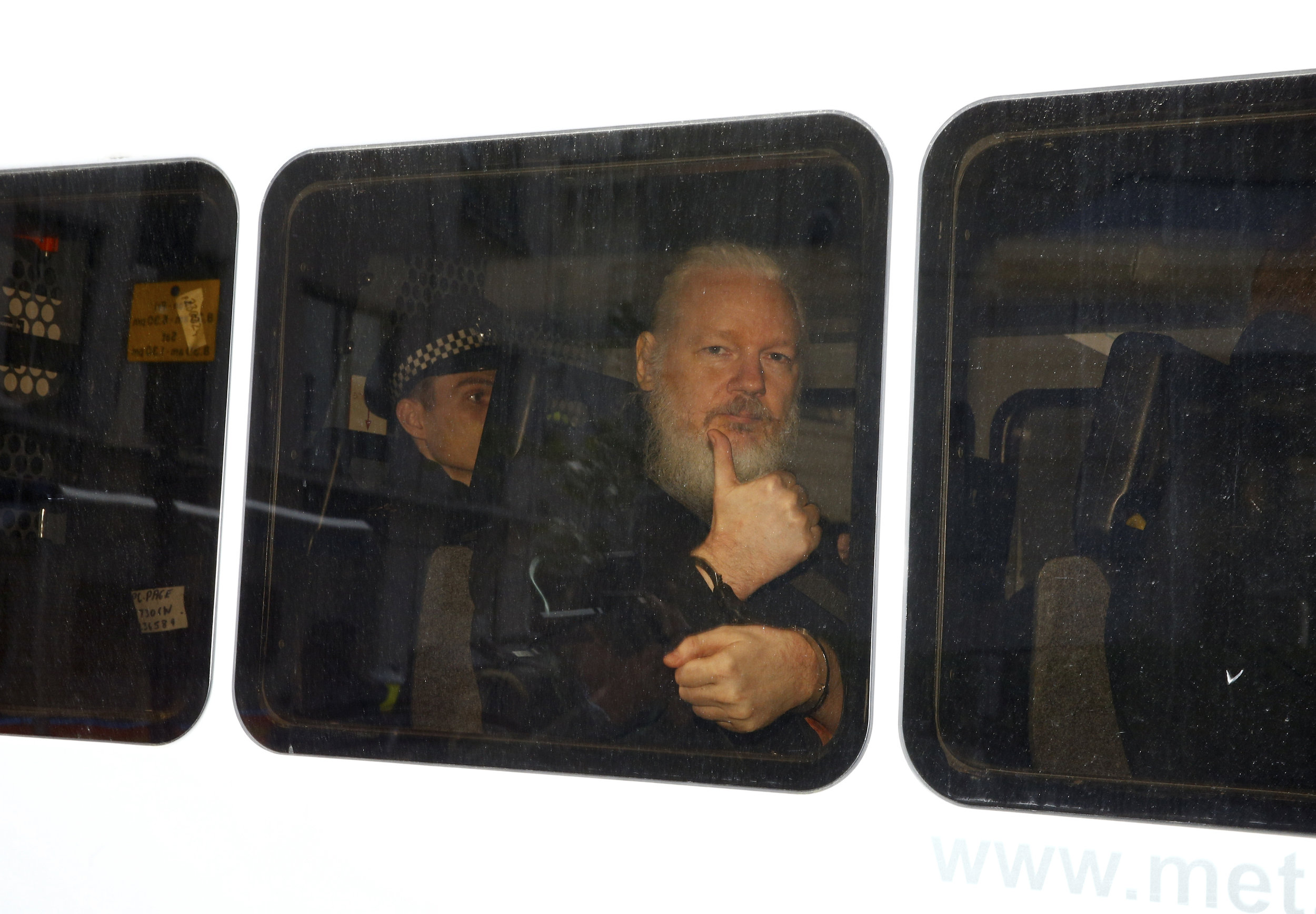  WikiLeaks founder Julian Assange is seen in a police van after being arrested by British police outside the Ecuadorian embassy in London.
Photo by Henry Nicholls, 11 April 2019
 