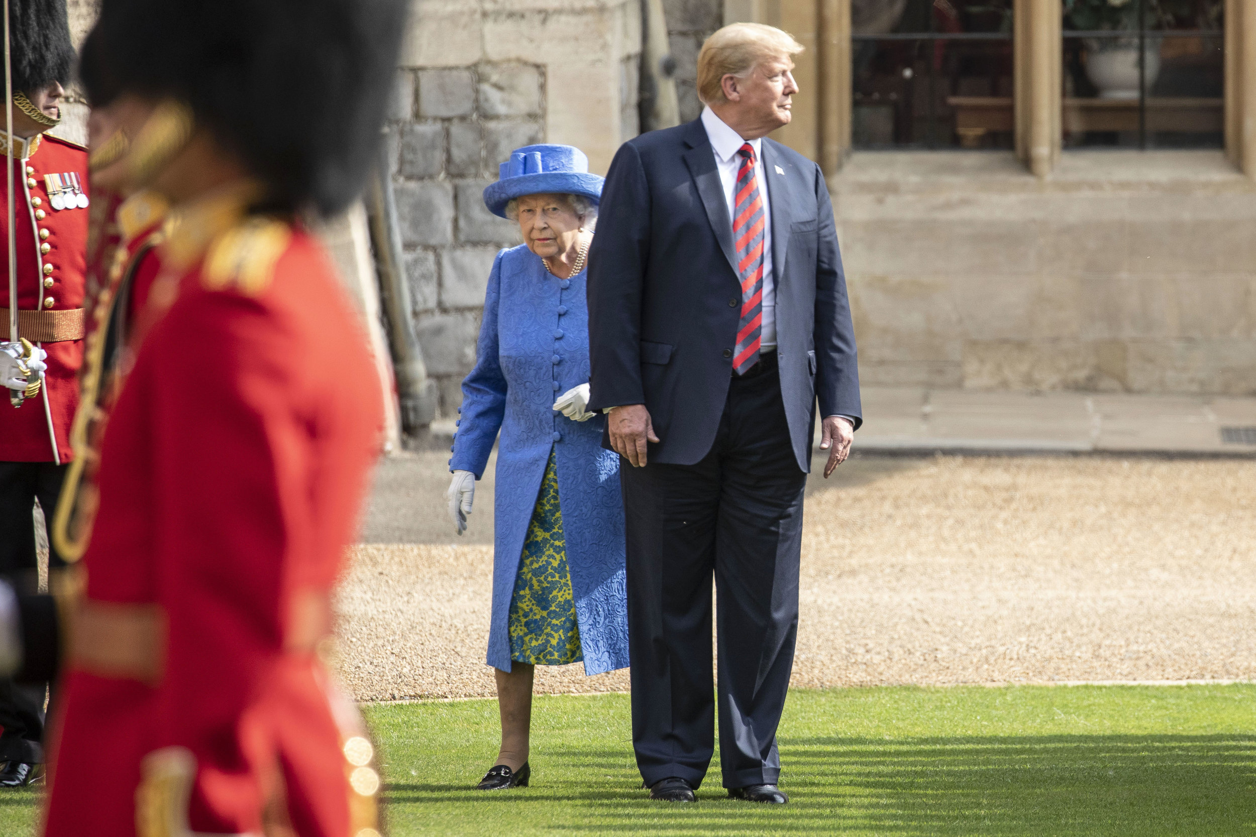  President Trump accidentally walks in front of the HM The Queen forcing her to side step around him as they inspect the Coldstream Guards at Windsor castle during the American President's official visit to the UK.
Photo by Richard Pohle, 13 July 201