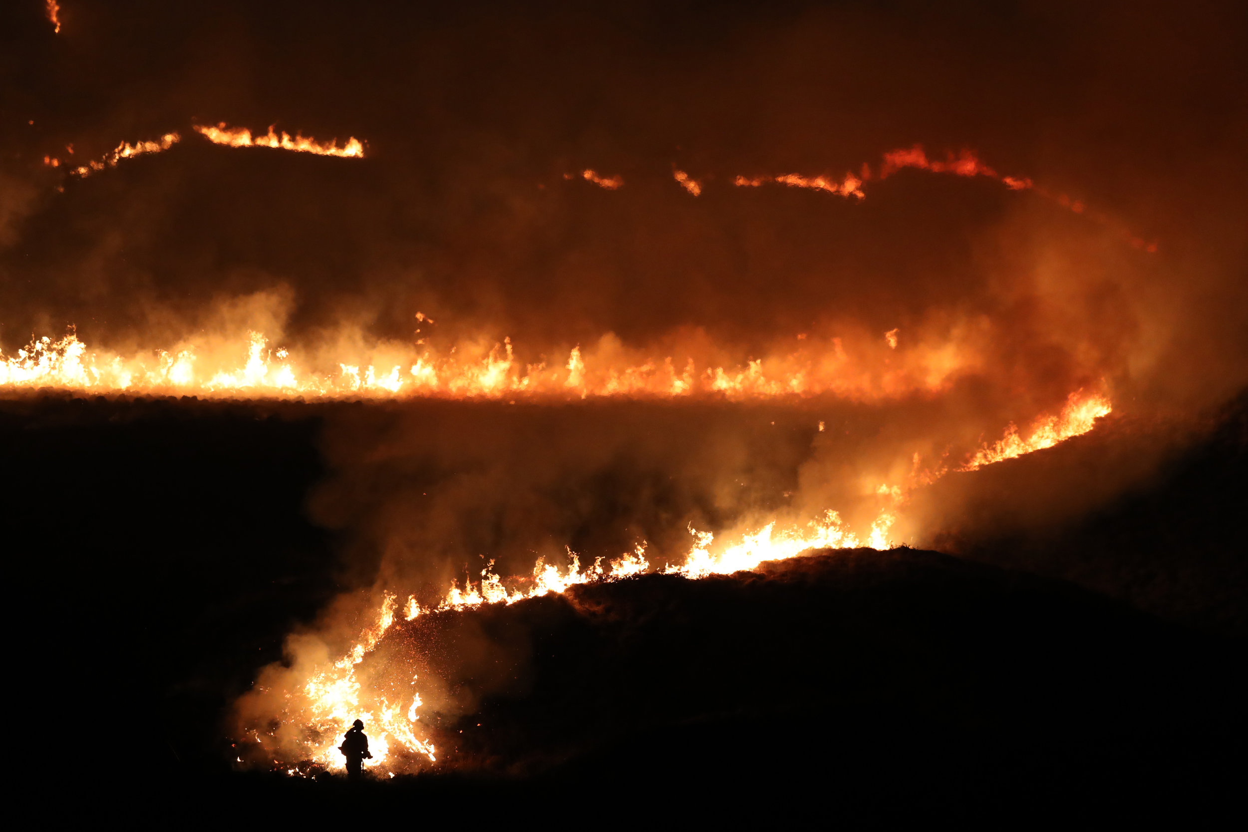  Firefighters tackle a fire burning on Saddleworth Moor near the town of Diggle in West Yorkshire after the UK�s warmest winter day on record. 
Photo by Jon Super, 27 February 2019
 