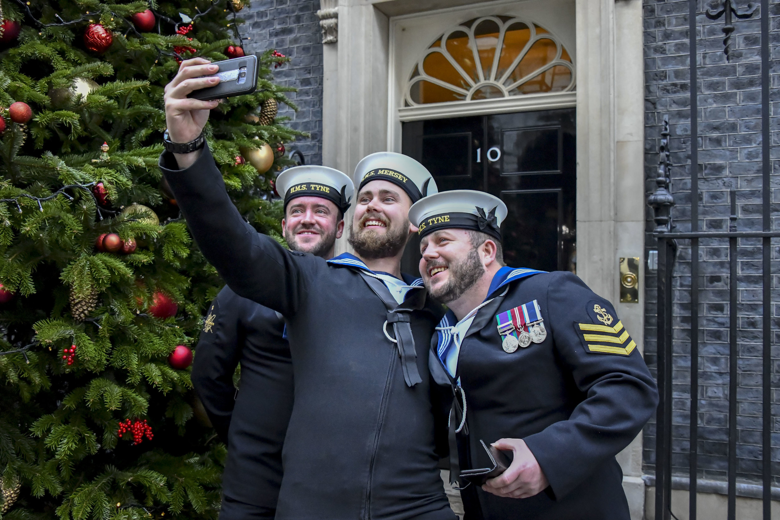  Three serving sailors from the Royal Navy take a selfie outside No10 Downing Street before attending The Sun Newspaper Military Awards 2018.
Photo by Ian Whittaker, 13 December 2018
 