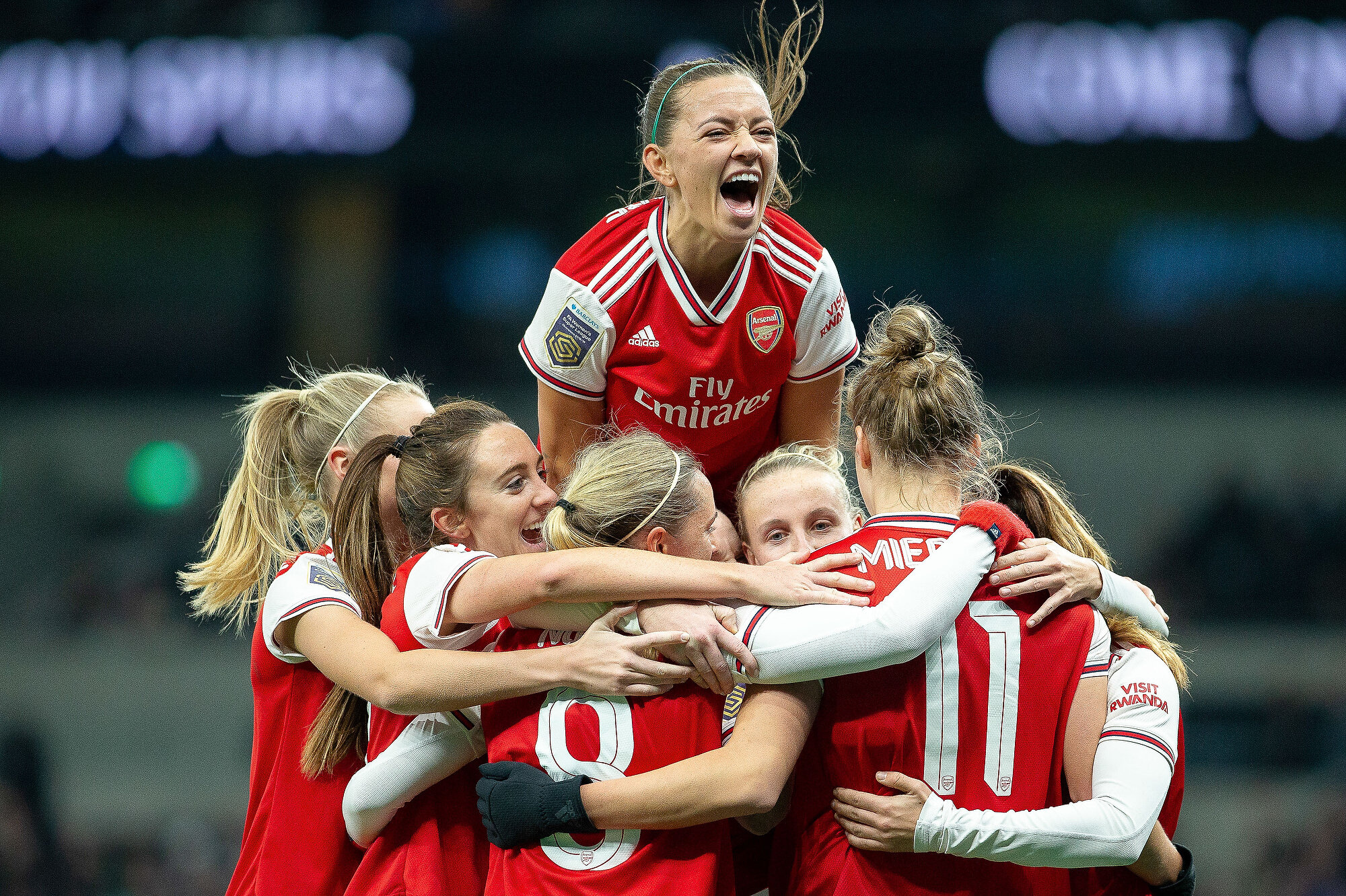  An ecstatic Katie McCabe of Arsenal jumps on top of her team mates as part of the goal celebrations after Vivianne Miedema scored their second goal in their away WSL game against Tottenham Hotspur. Photo: Elli Birch, 17 November 2019 