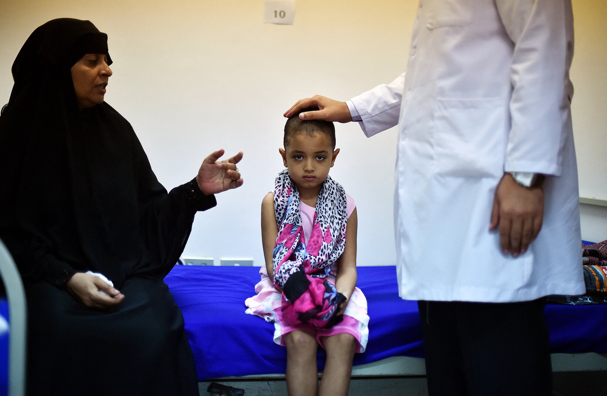  Seven year old Yemeni refugee Farah Abdallah who still has a bullet lodged in her head sits in hospital in Djibouti after being shot in the head by a sniper in Aden before fleeing with her mother with other refugees. Photo: Carl de Souza/AFP, 05 May