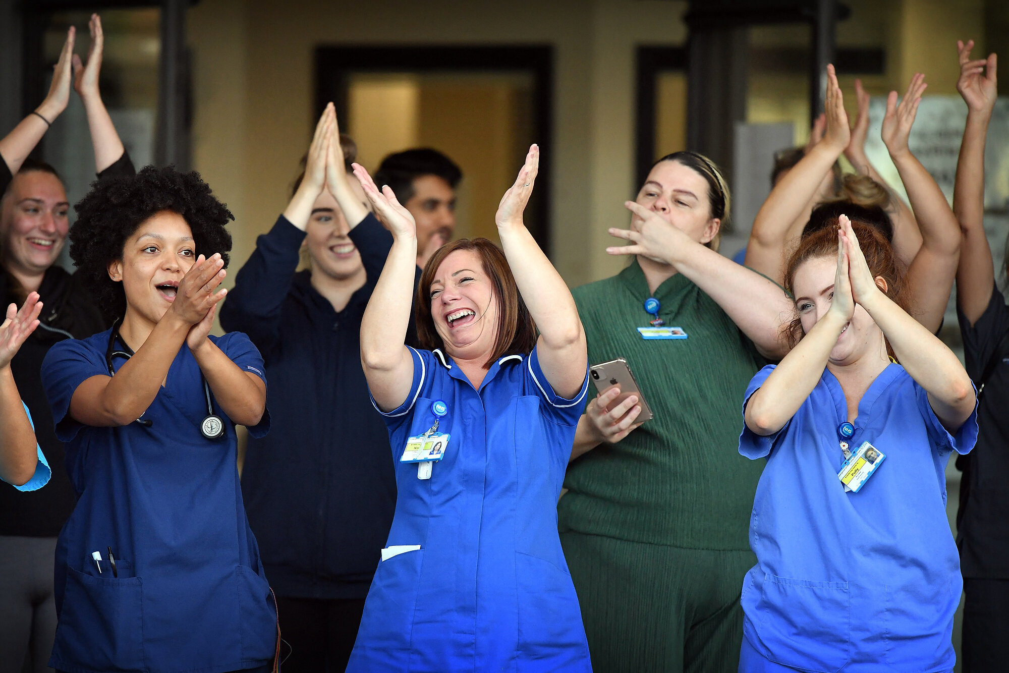  NHS workers at Aintree University Hospital in Liverpool participate in a national "clap for carers" to show thanks for the work of Britain's NHS and other frontline medical staff around the country as they battle with the novel coronavirus pandemic.