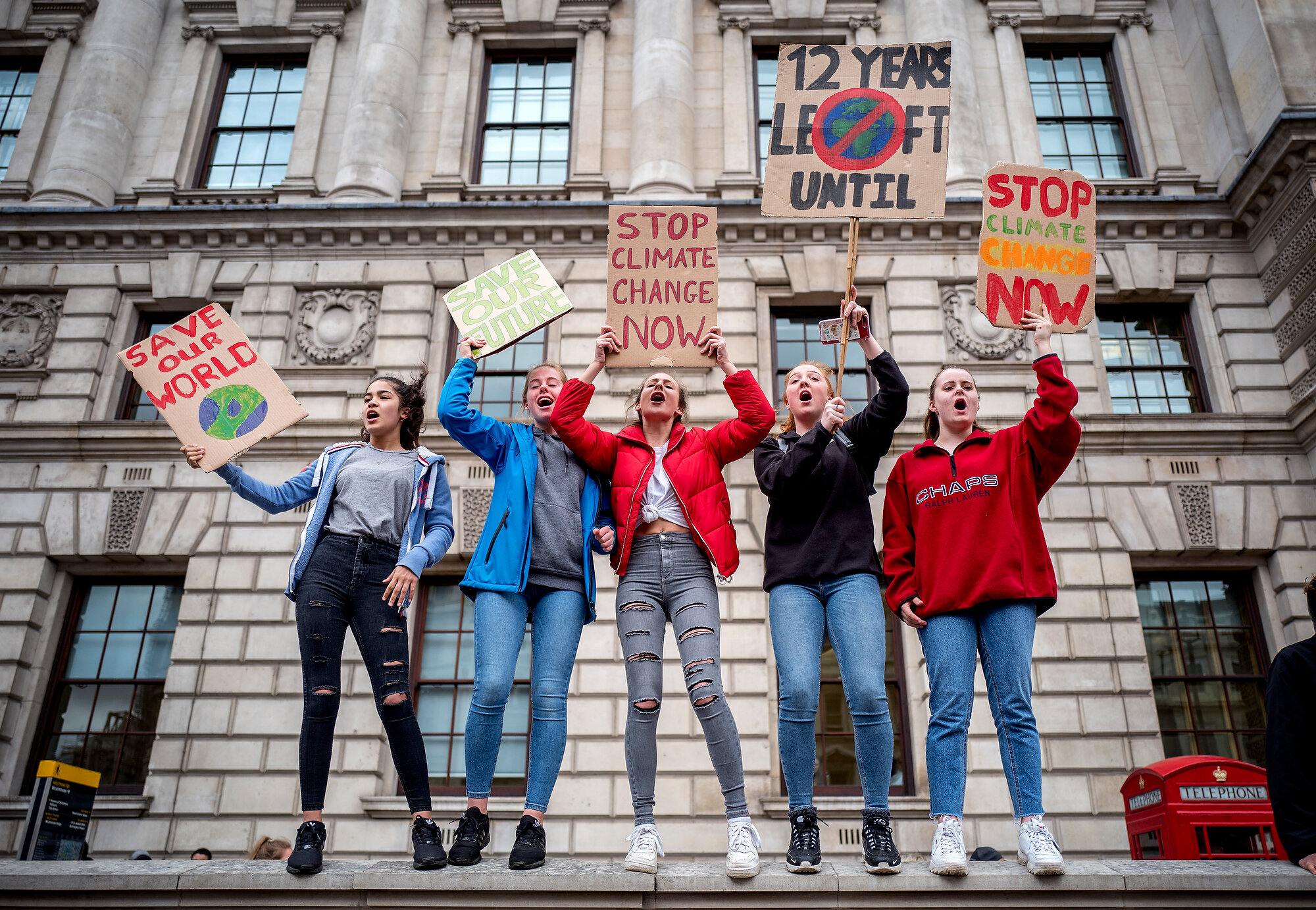  Young demonstrators hold placards as they attend the "Global Strike 4 Climate" protest march in central London. Many of the hundreds of young people had gone on strike from school as part of a global youth action over climate change.  Photo: Tolga A