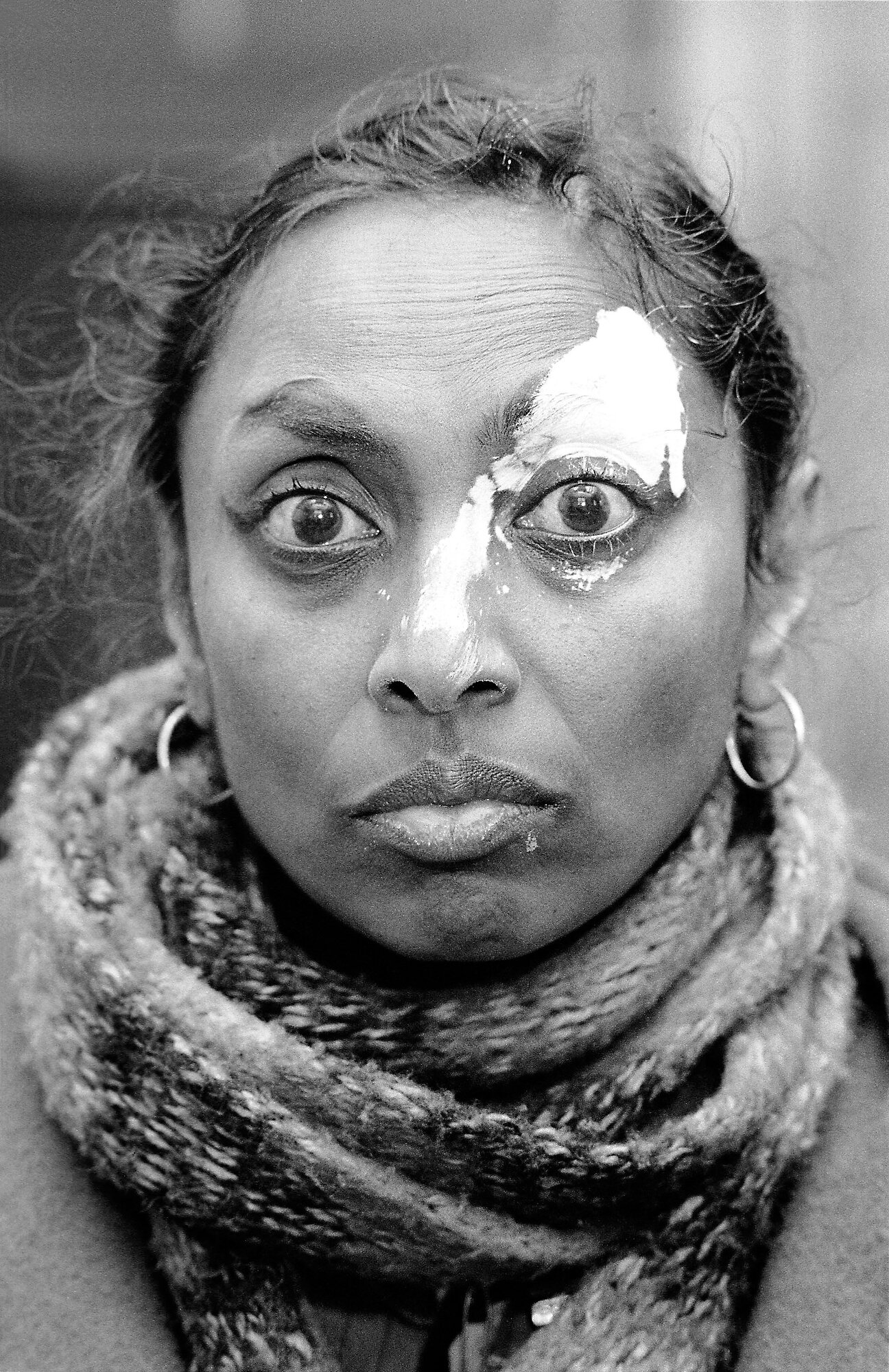  Mrs PJ stands steadfast and determined after being attacked by a local racist gang who threw white paint in her face as she left her council flat in Hackney. Photo: David Hoffman, 08 February 1988 