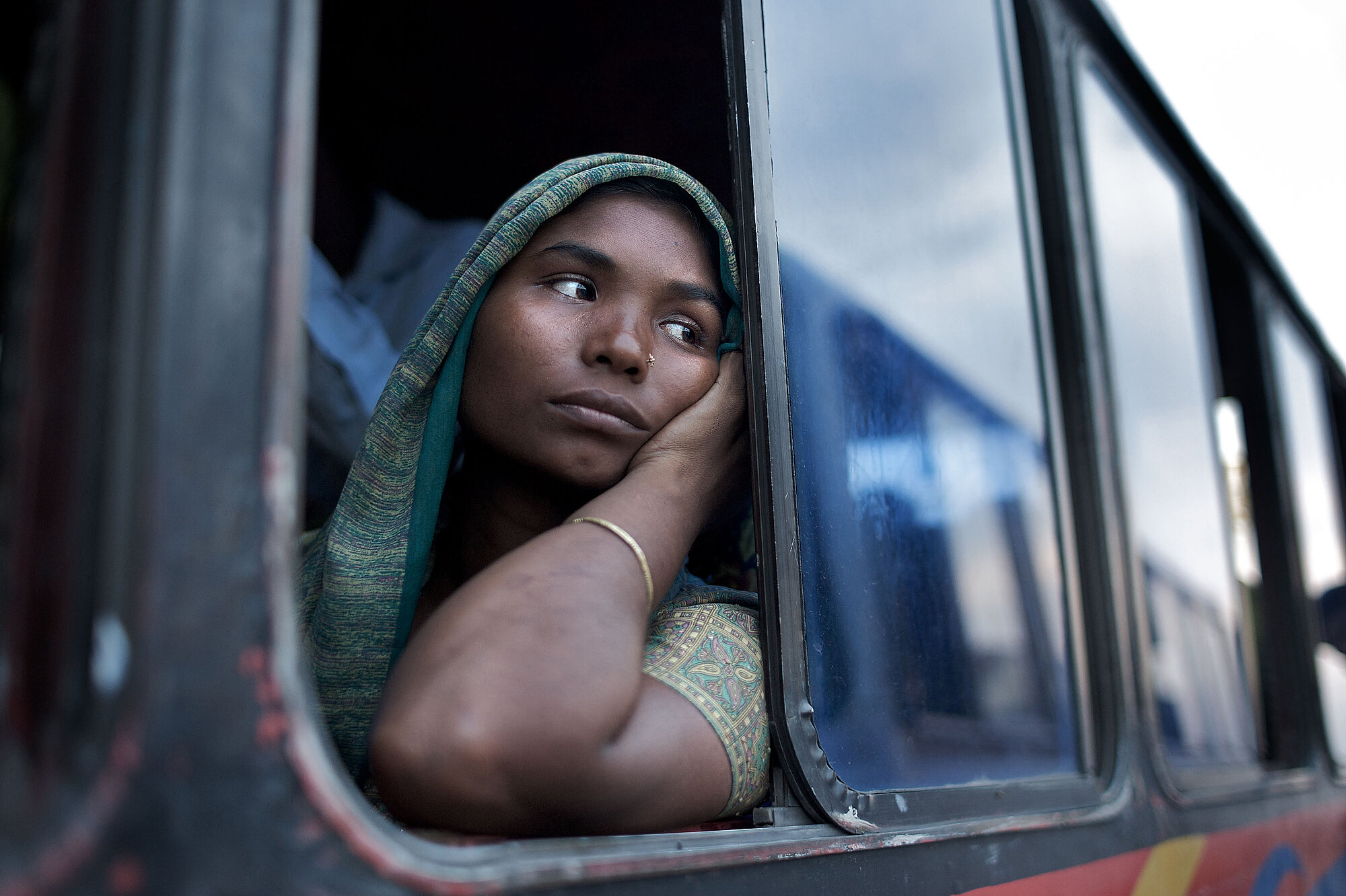  A bus passenger waits for the vehicle she is travelling on to board a ferry in southern Bangladesh.Photo: David White, 16 September 2009 