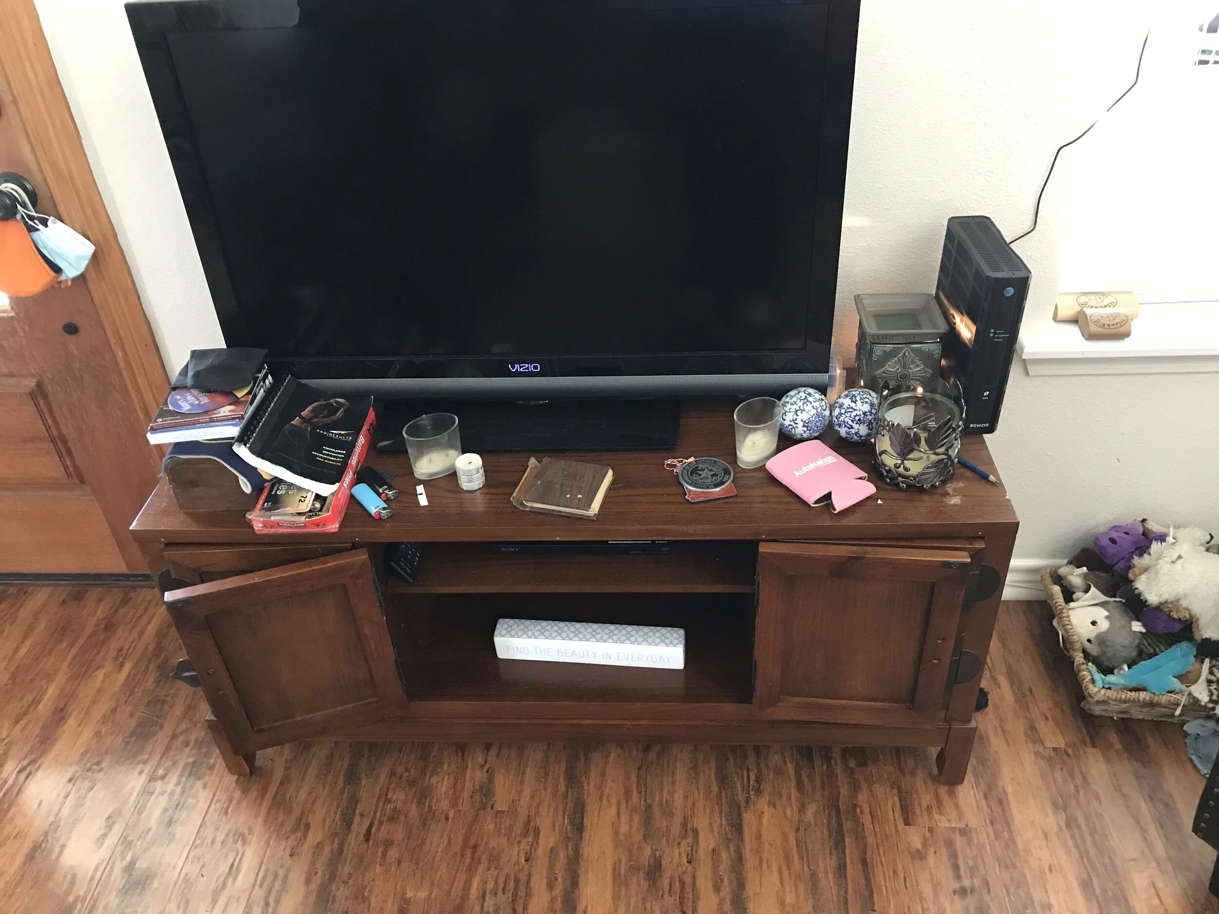 Before picture, cluttered entertainment center in San Antonio