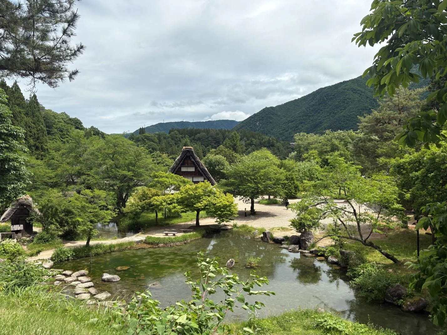 Historic village with thatched roof houses and a pond
