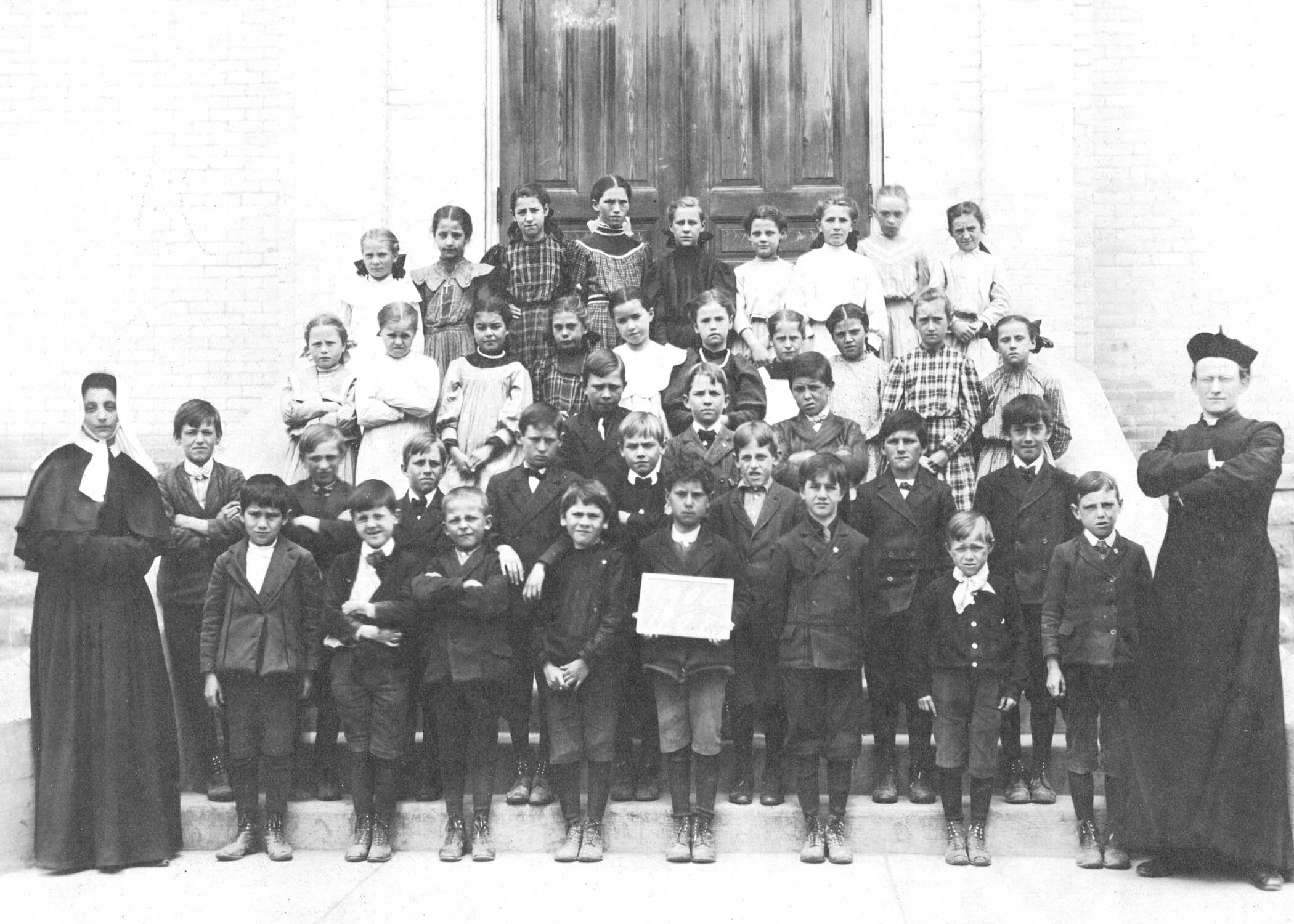 Bonnie Moschkau - 1906-07 Primary grades with nun & Fr. Koester.jpg