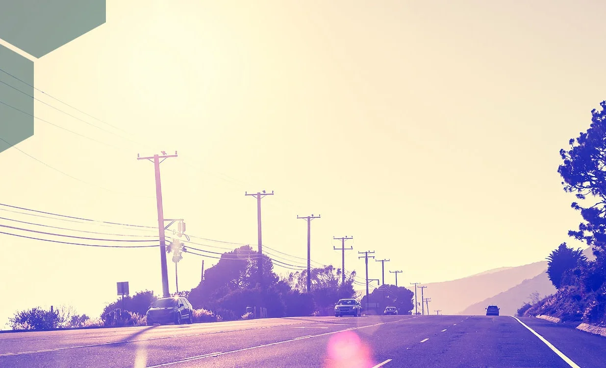 a scenic picture of telephone poles in a line