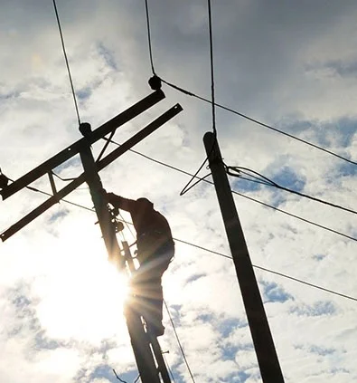a technician servicing a telephone pole