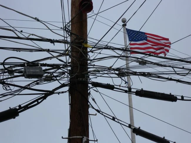 an extremely messy telephone pole