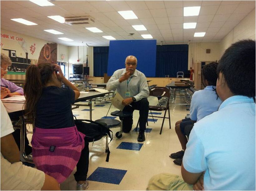 gnc teacher in lunchroom kneeling.jpg