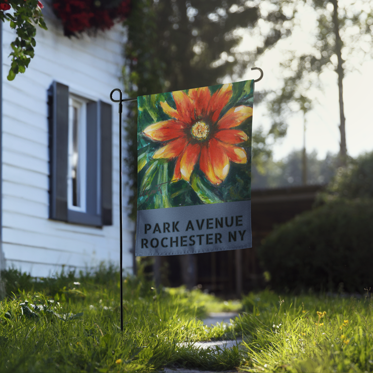 Park Avenue Rochester NY garden flag with Frank Argento’s orange gazania flower, on a stand in a front yard
