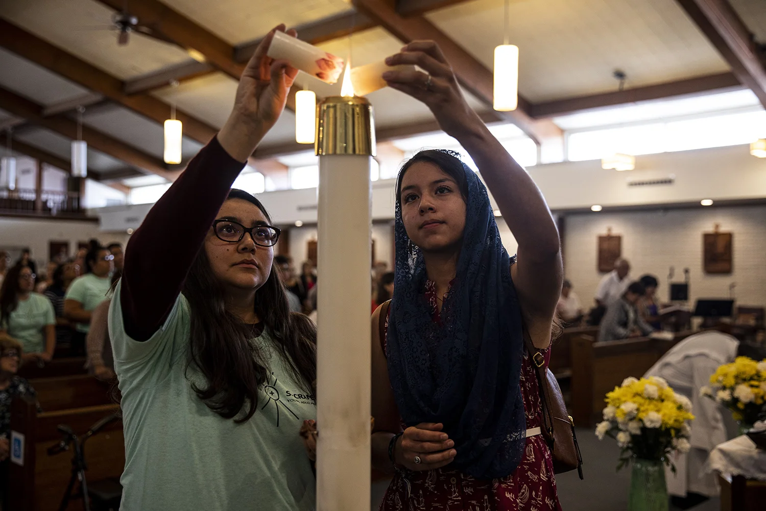 Parishioners during a vigil for the Walmart shooting st the Blessed Sacrament Parish in El Paso.