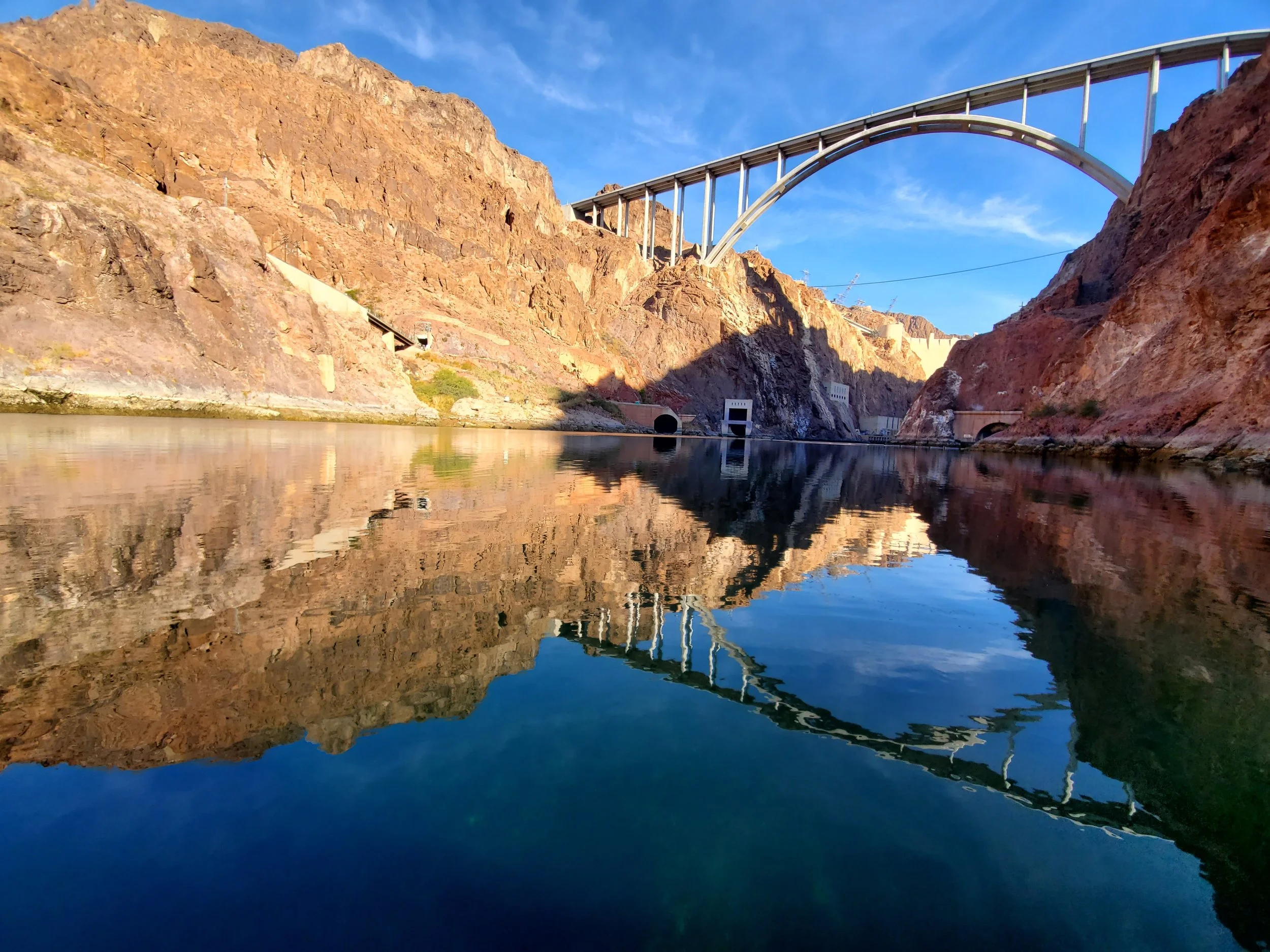 looking up at the bridge and dam from the colorado river