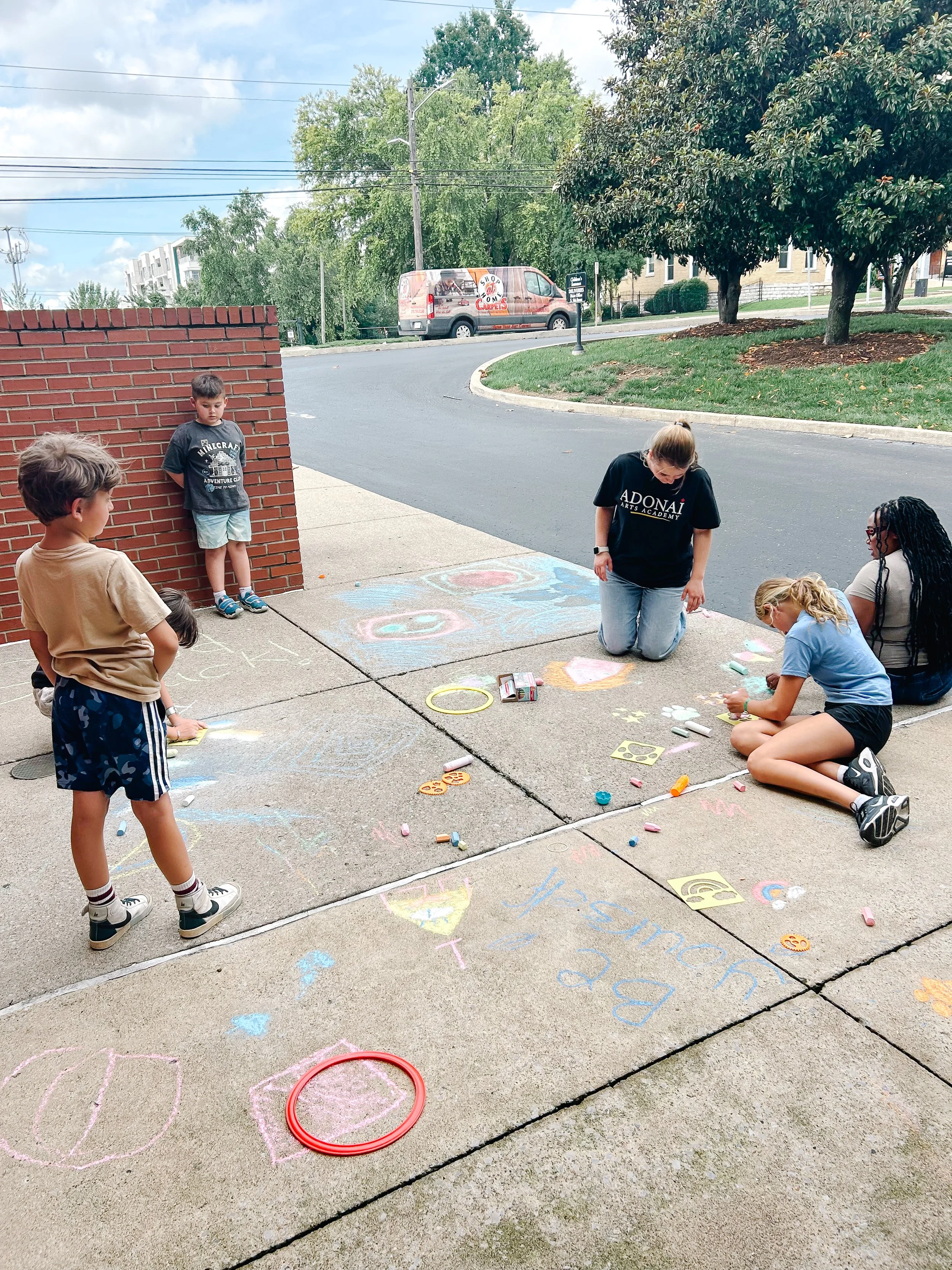 Children outside during the summer playing with chalk in Nashville, Tennessee