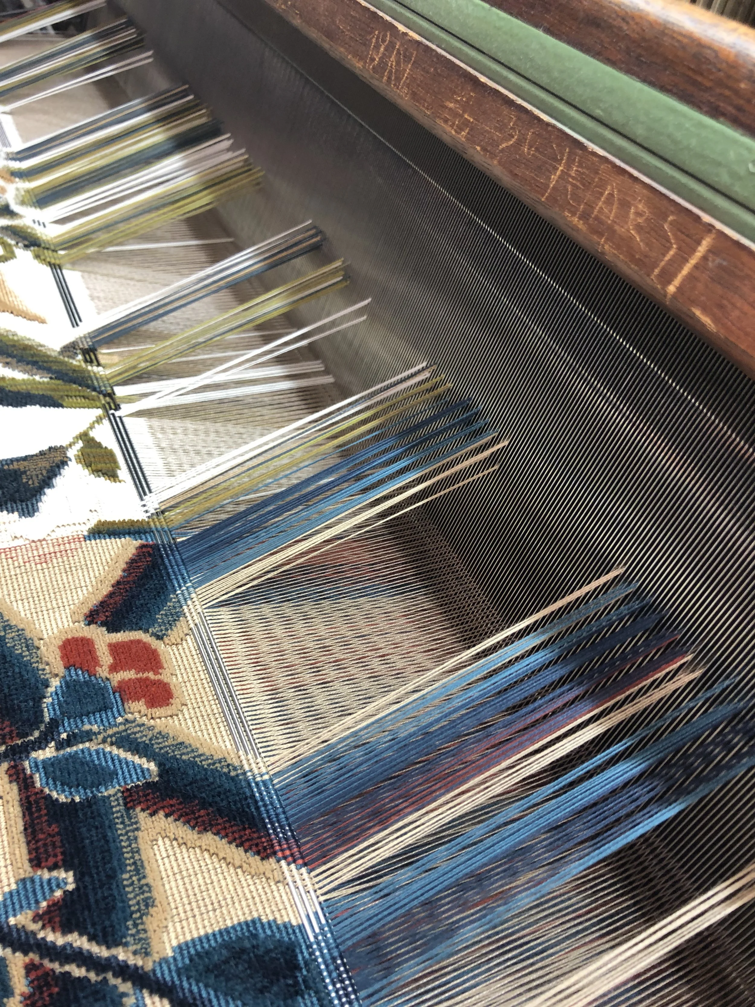 A cut and loop epinglé being woven on a wire loom