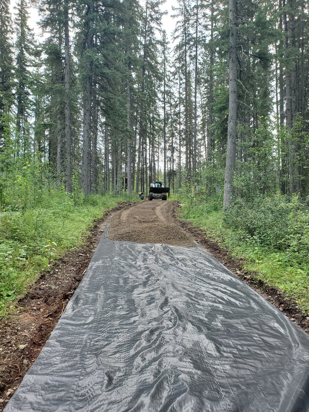 Laying gravel overtop geotextile