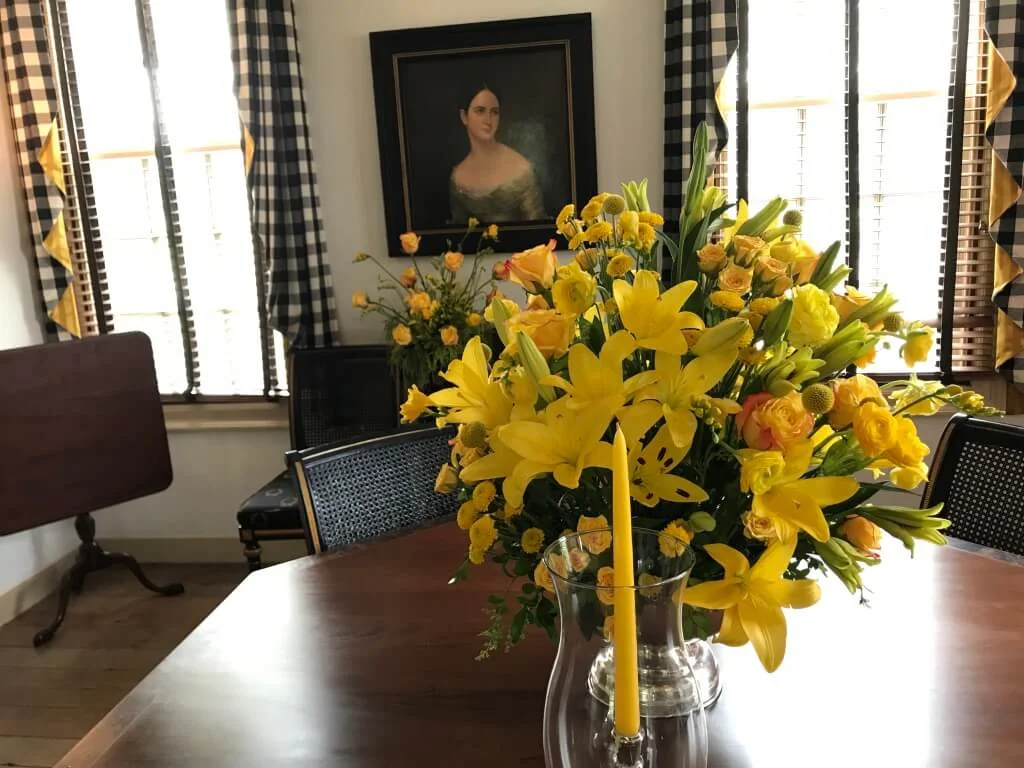 Beautiful arrangement of Lily, Ranunculus, Rose, Spray Rose, Freesia, Mums, Seeded Eucalyptus and Craspedia by a Williamsburg Garden Club Member.