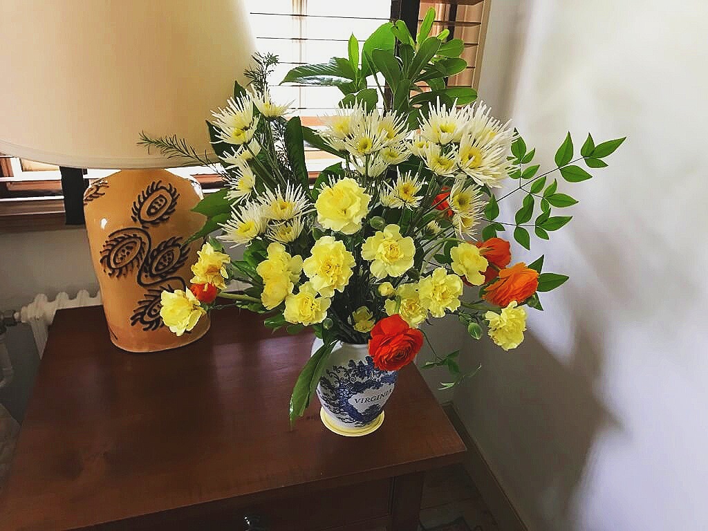 Beautiful springtime bedroom arrangement with perfect orange Ranunculus that make the entire design pop! ©betsygibsondesign