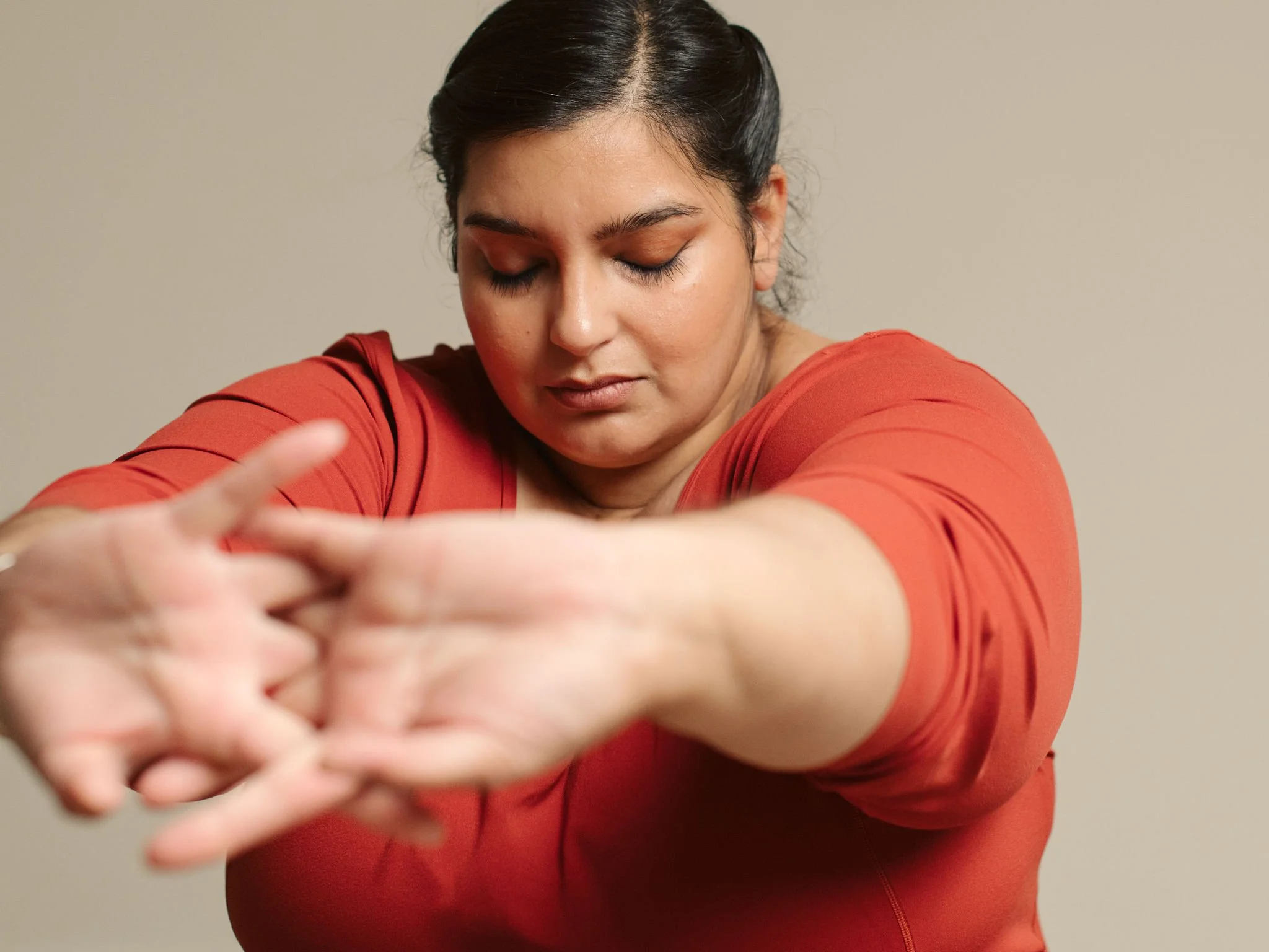 a woman stretching signifying drop-in yoga classes