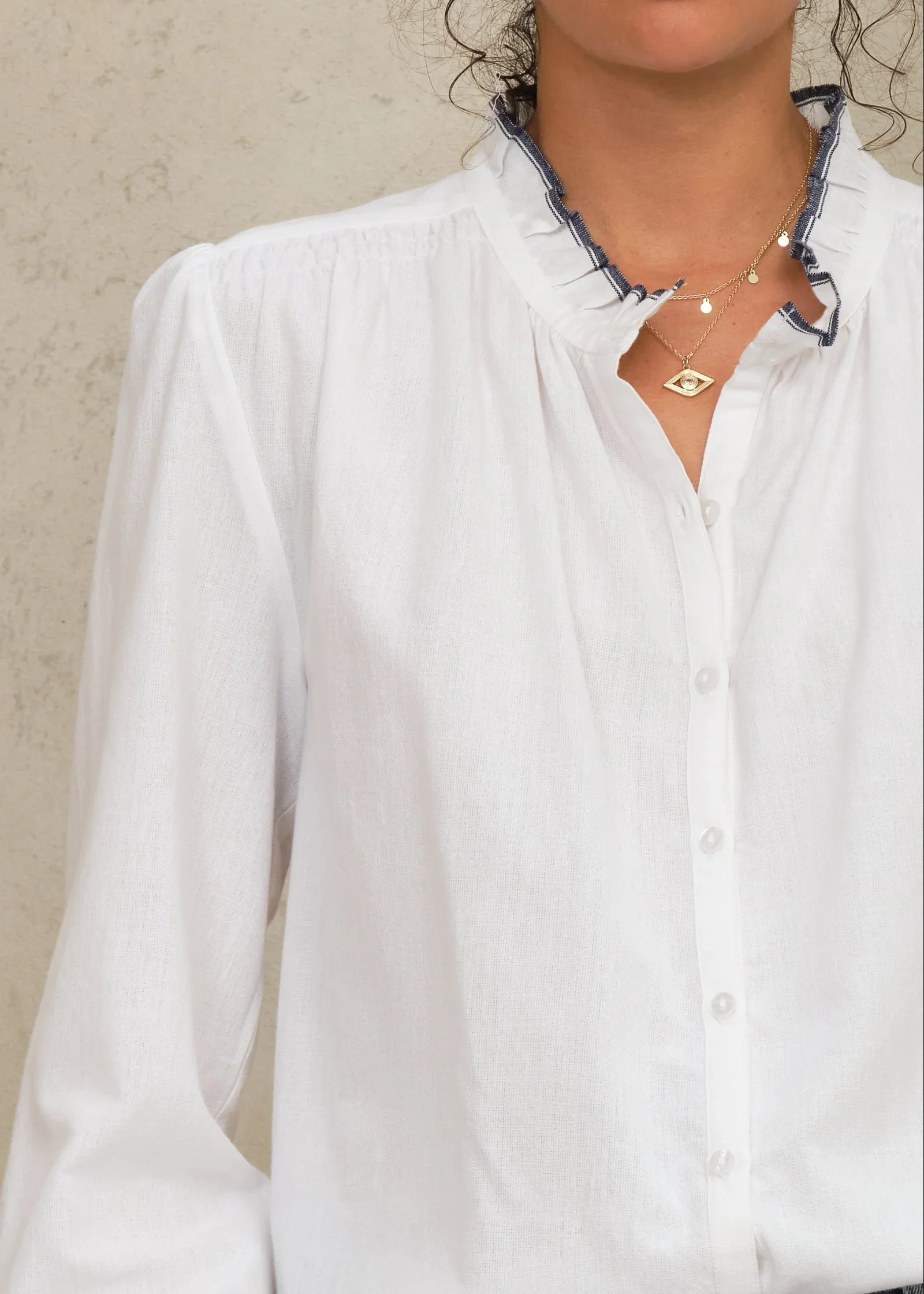 M.A.B.E Apparel ivory blouse detail shot on model