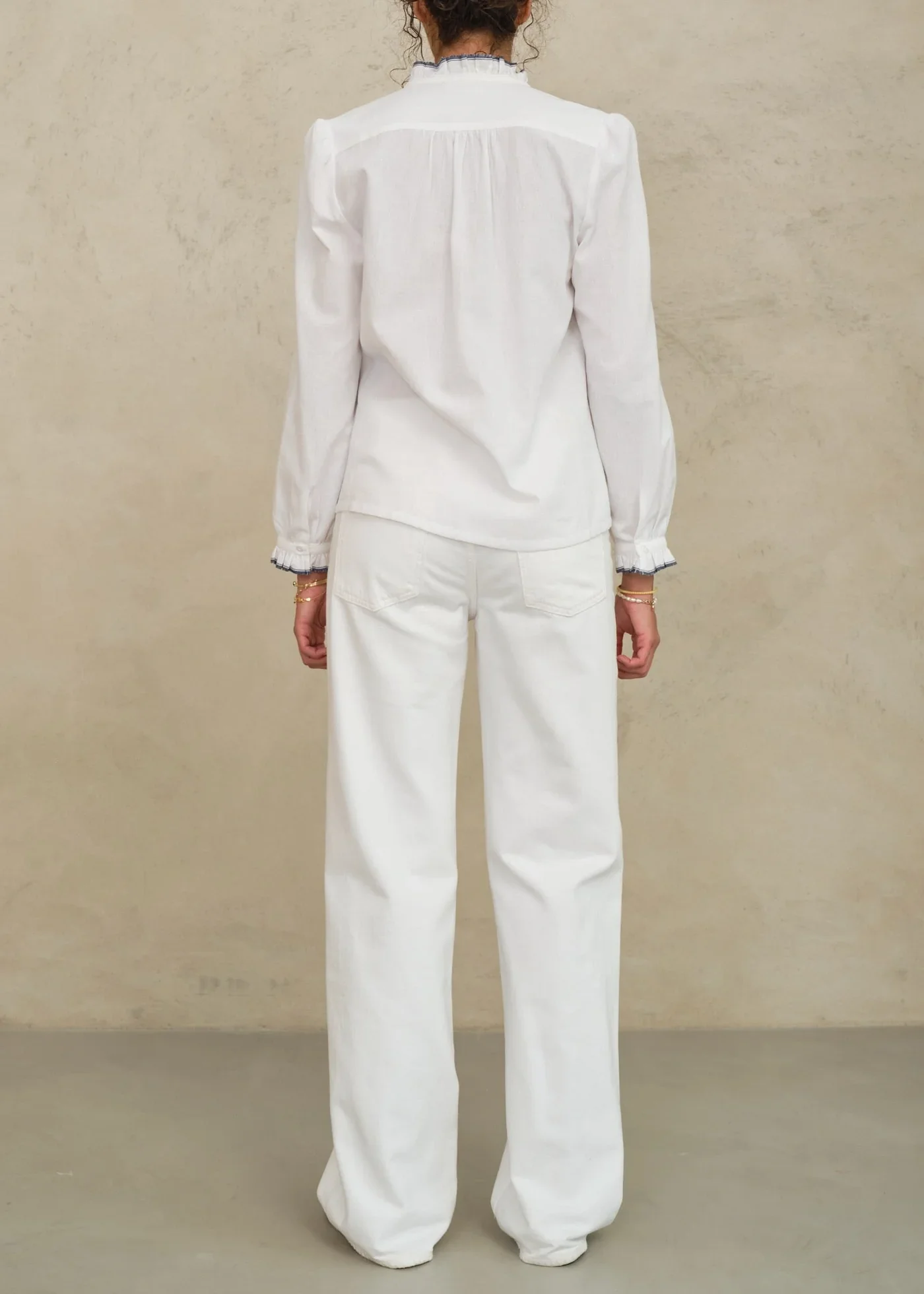 M.A.B.E Apparel ivory blouse back view on model