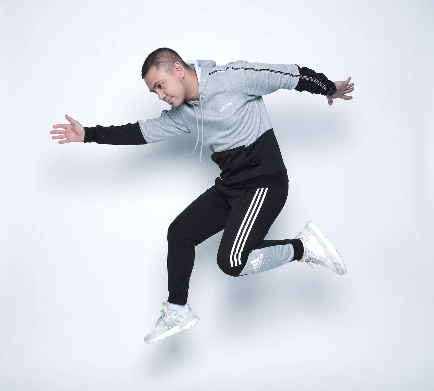 Athlete captured in a dynamic pose against a light studio background.