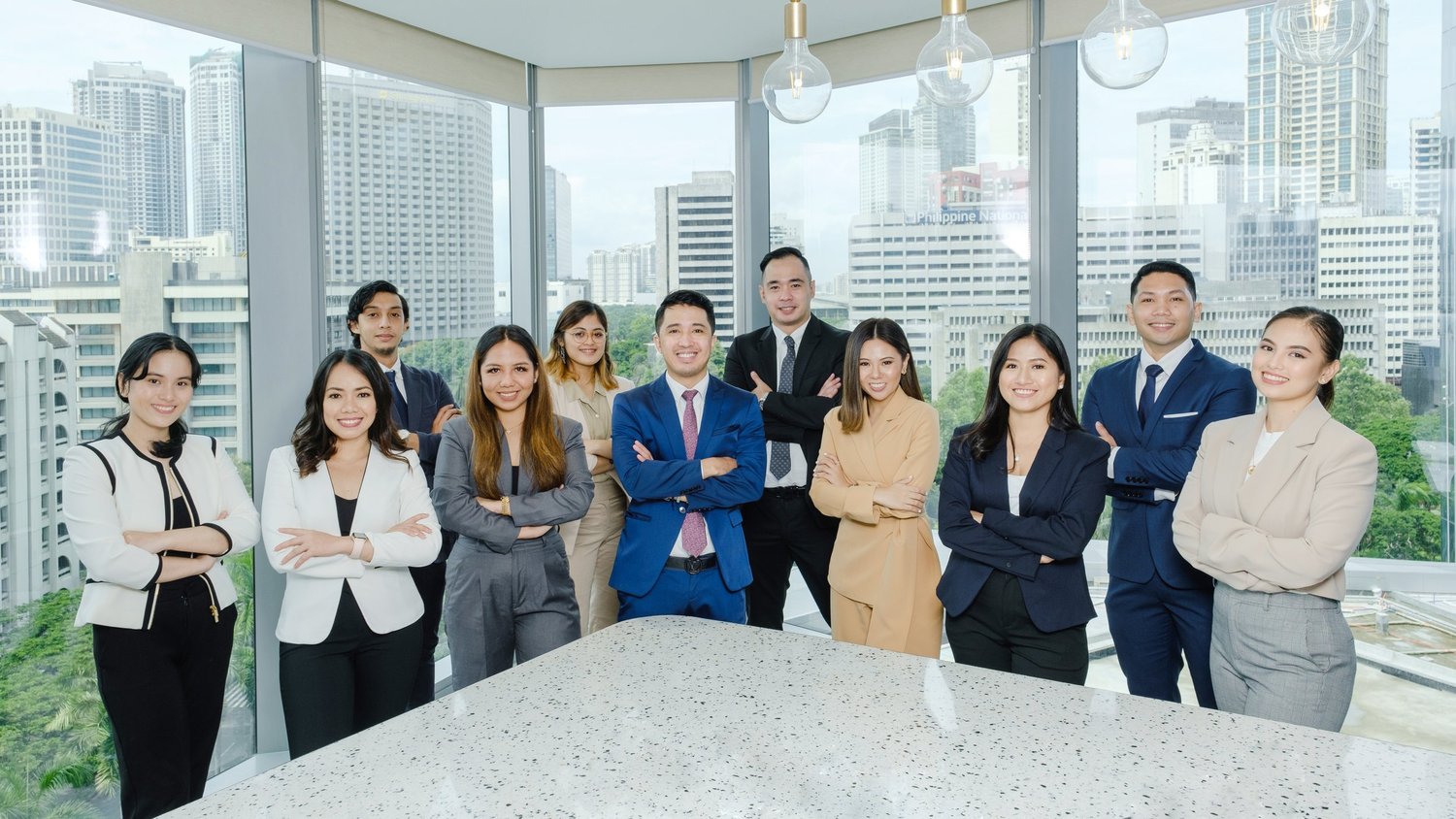 Corporate team gathered in a bright office with city views.