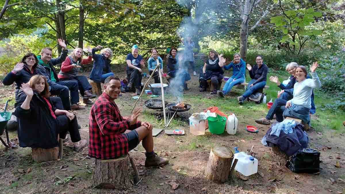 cambium-sustainable-forest-school-training-outdoor-learning-VALUE-SUPPORT-wellbeing-TRAINERS-NETWORK-MOOT-CAMPFIRE-LUNCH-WAVING.jpeg