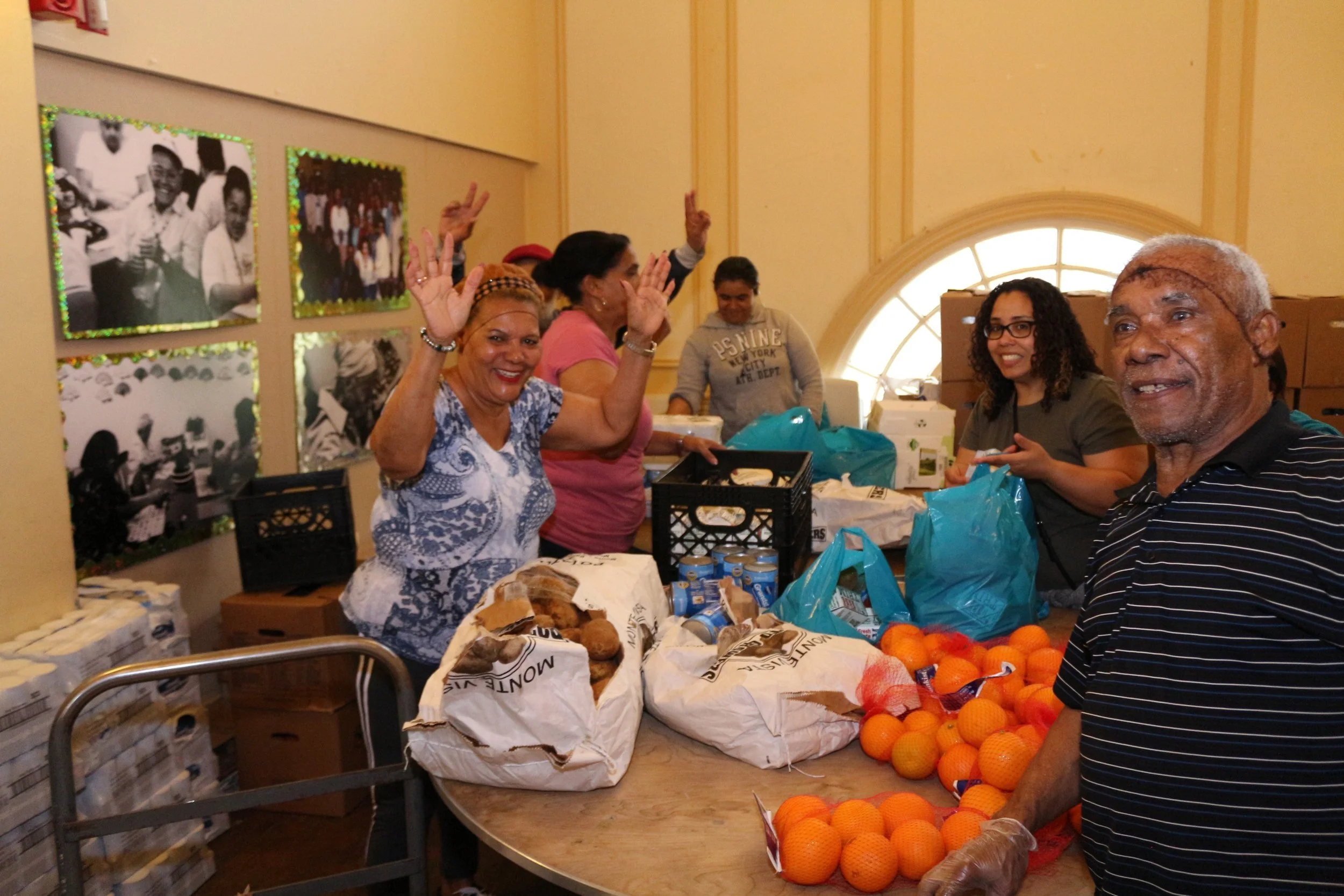 Group of people sorting food for donation in a community center