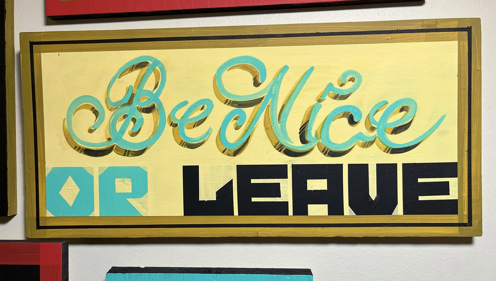 Be Nice Or Leave, 2025, house paint on wood, about 9x20