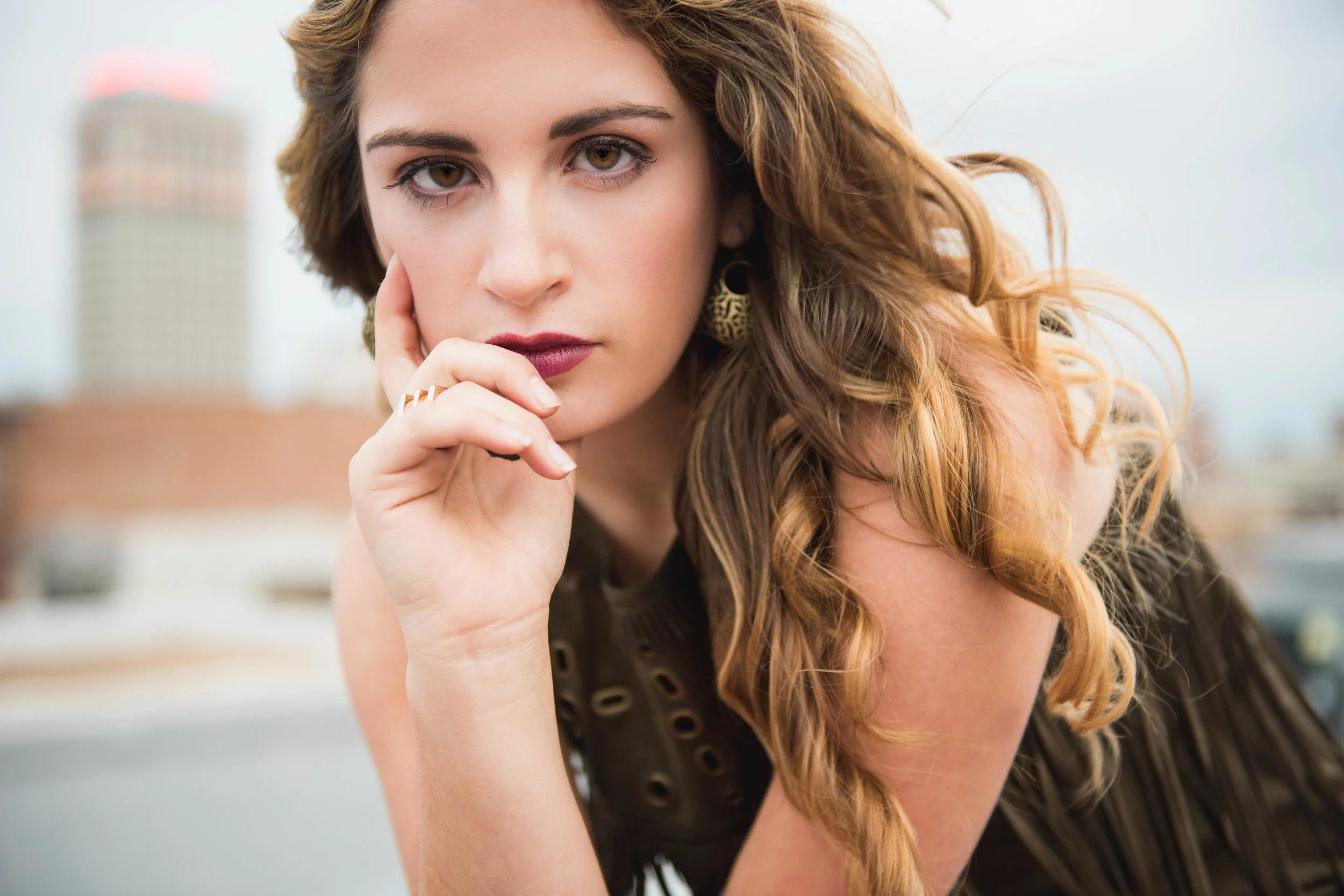close up of Hannah with her hand framing her face in pell city outdoor senior session