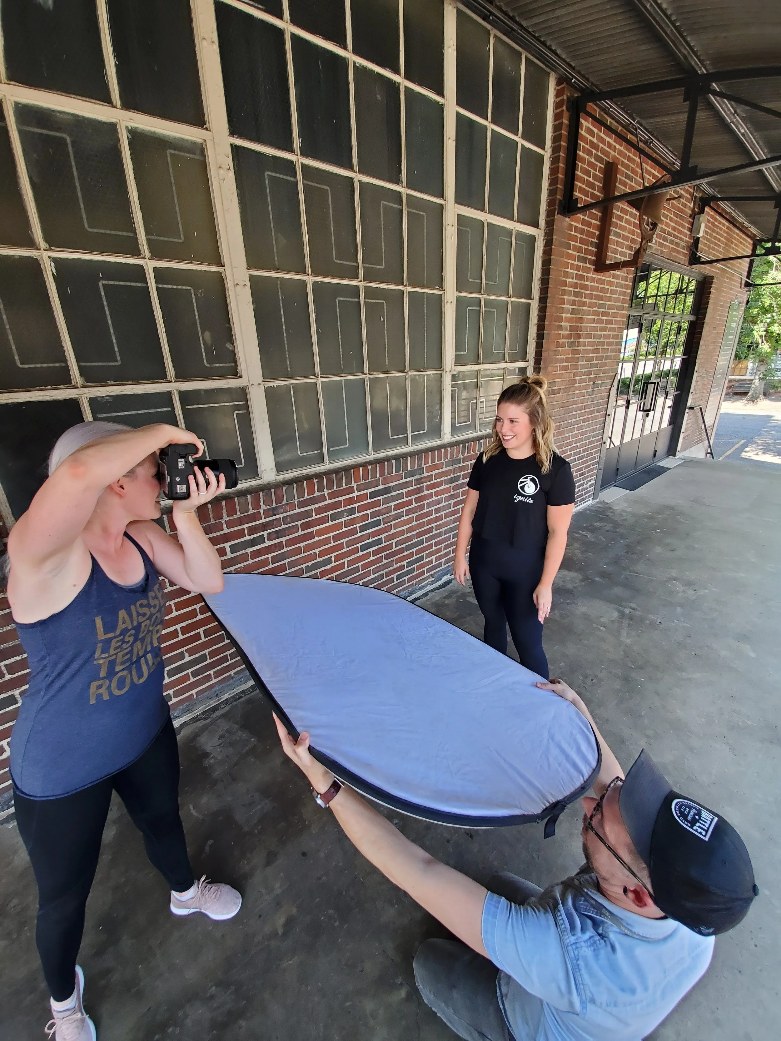 Behind the scenes of Darling & Dear photographing instructor outdoors while also holding reflector
