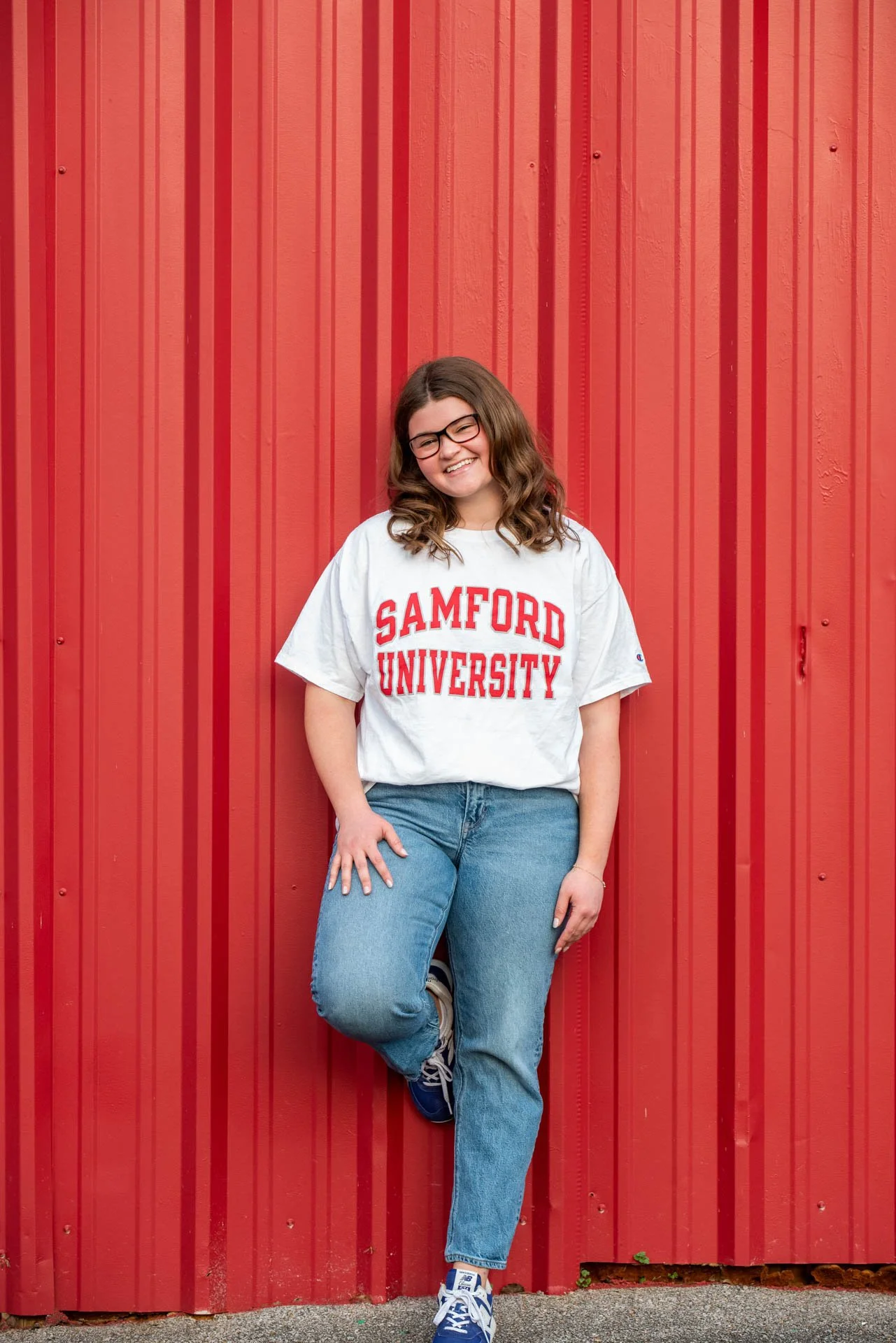 Senior girl in Samford University shirt in front of red barn wall Pell City Alabama, Darling Dear Photo