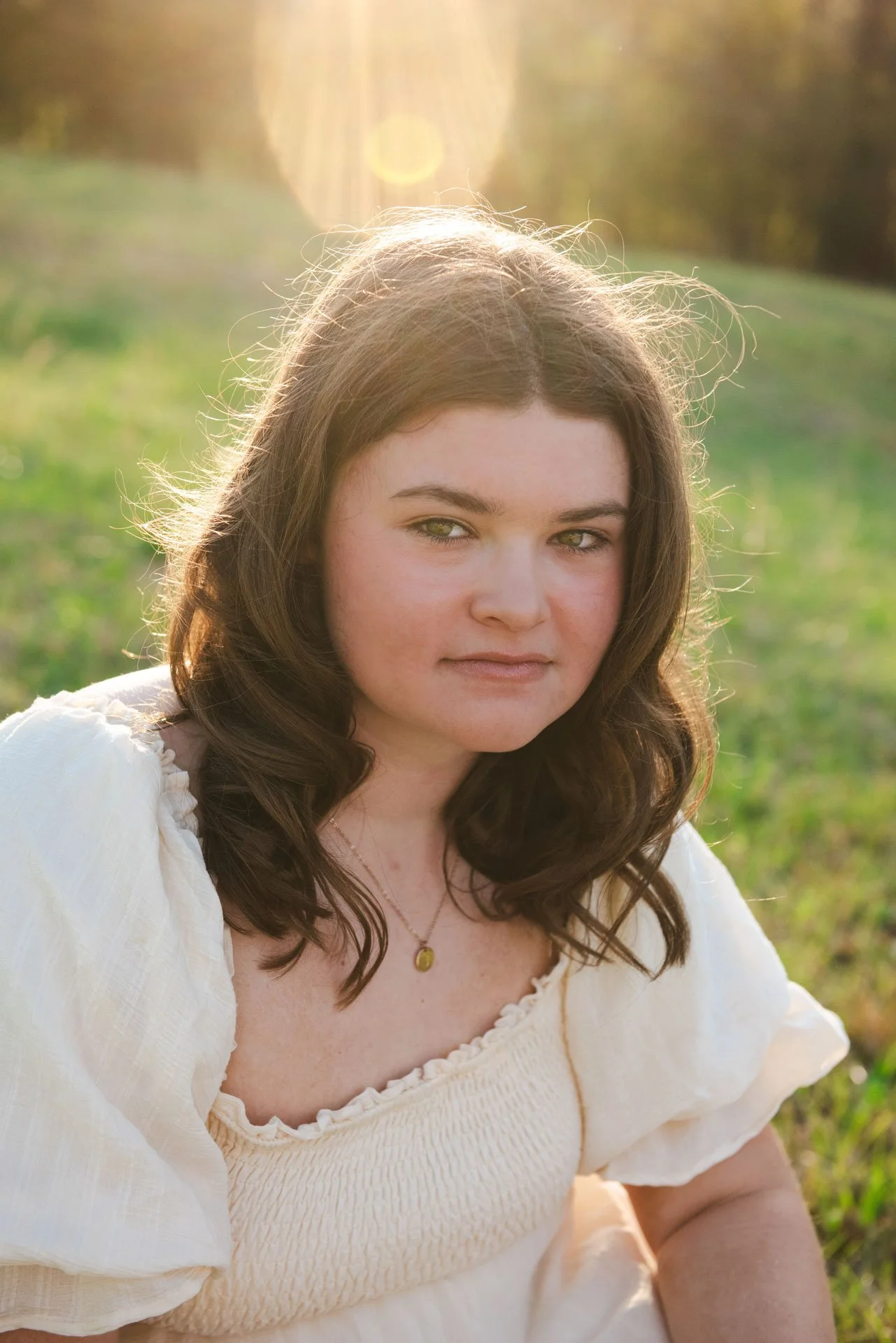 Senior girl in cream dress close up of her sitting in field at golden hour Pell City Alabama, Darling Dear Photo