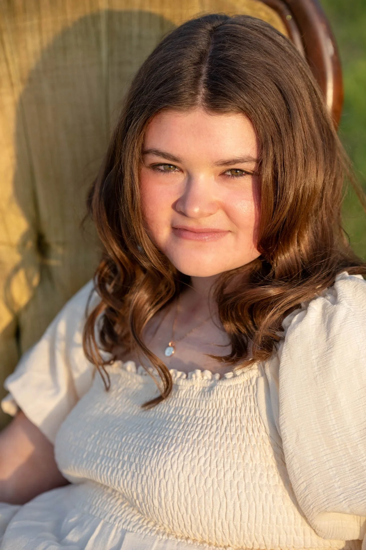 Senior portrait sitting in vintage velvet chair at golden hour Pell City Alabama, Darling Dear Photo