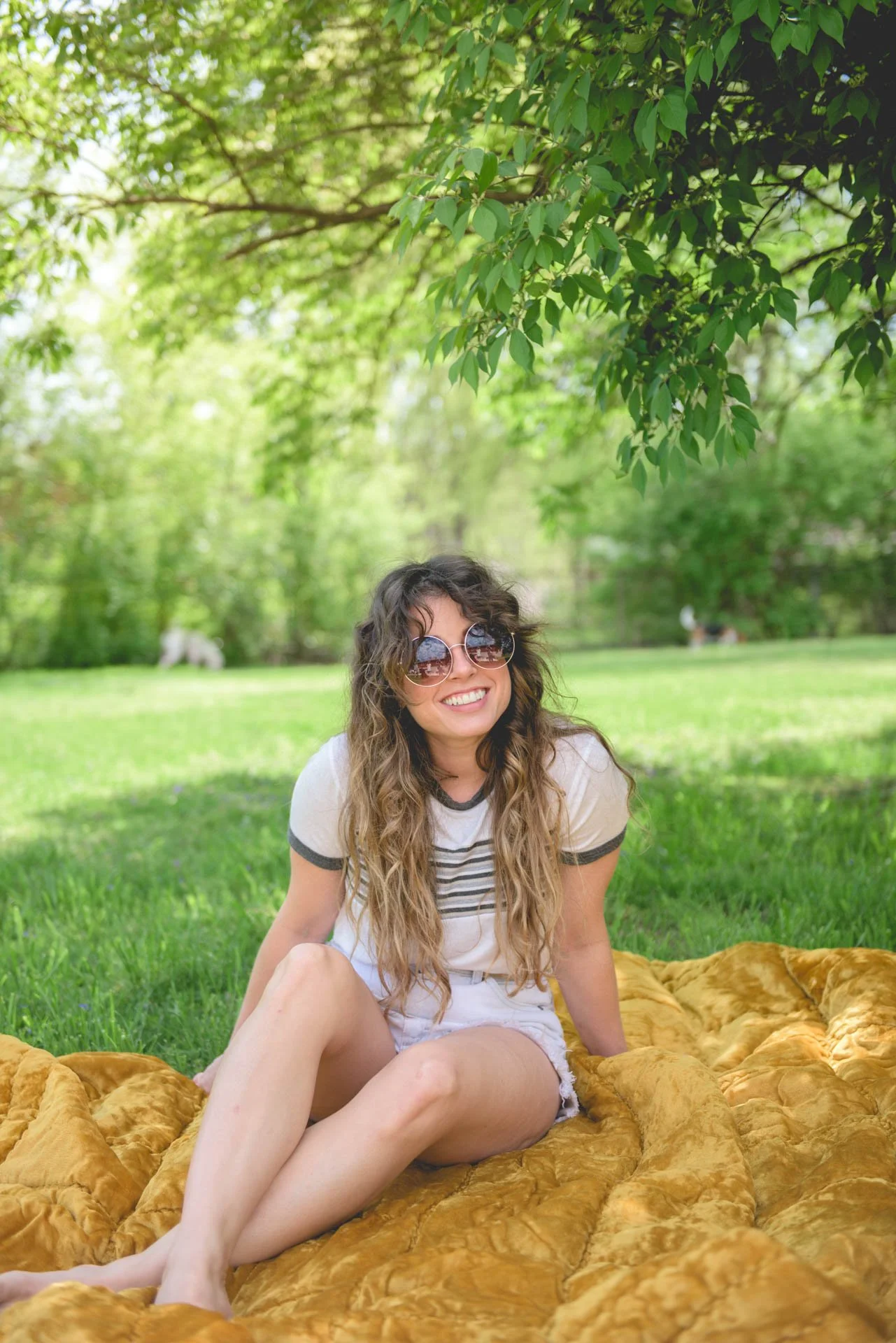 molly green clothing branding session with owner on velvet blanket under a tree with sunglasses on in alabama