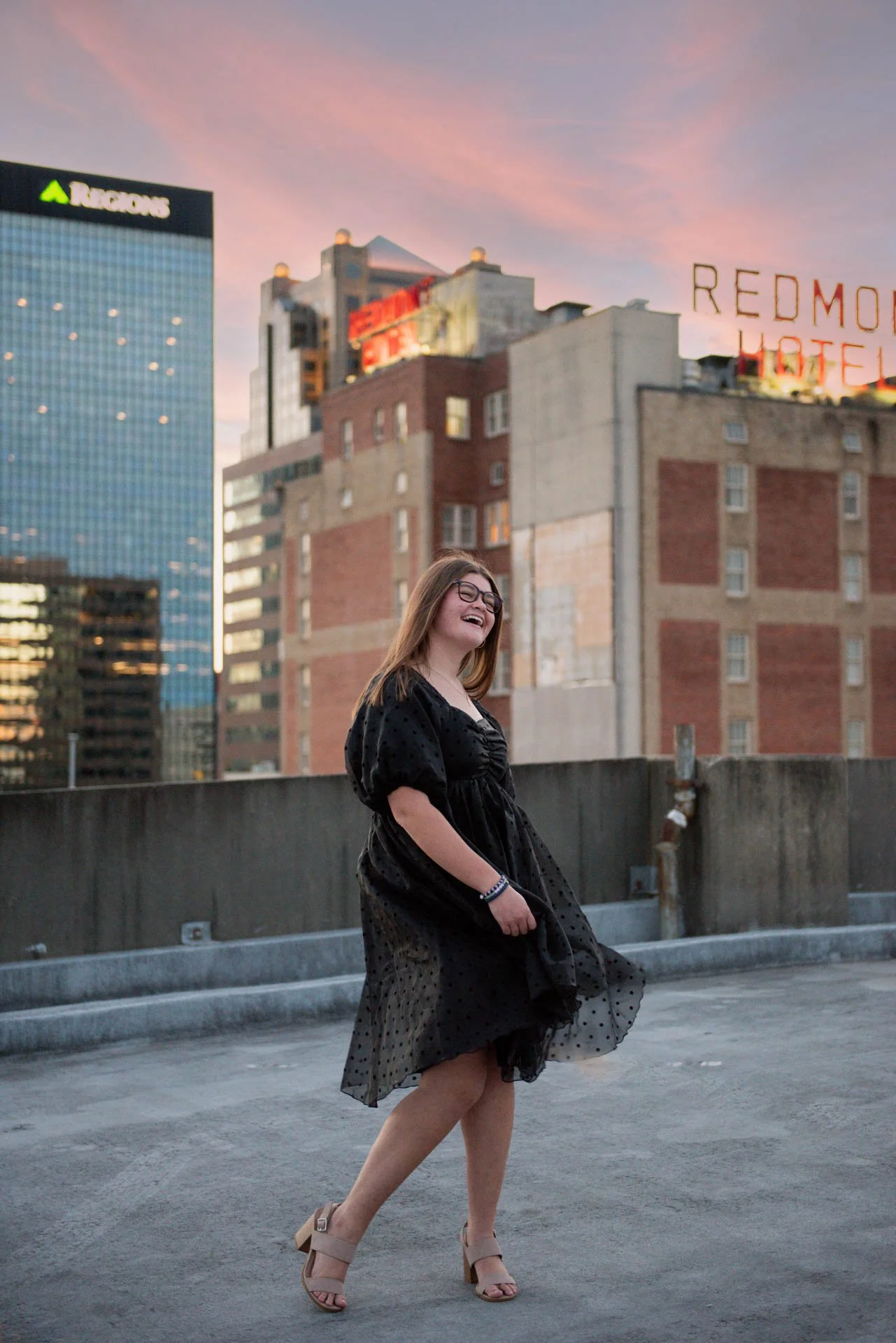 Senior girl laughing on Birmingham rooftop at golden hour, Darling Dear Photo