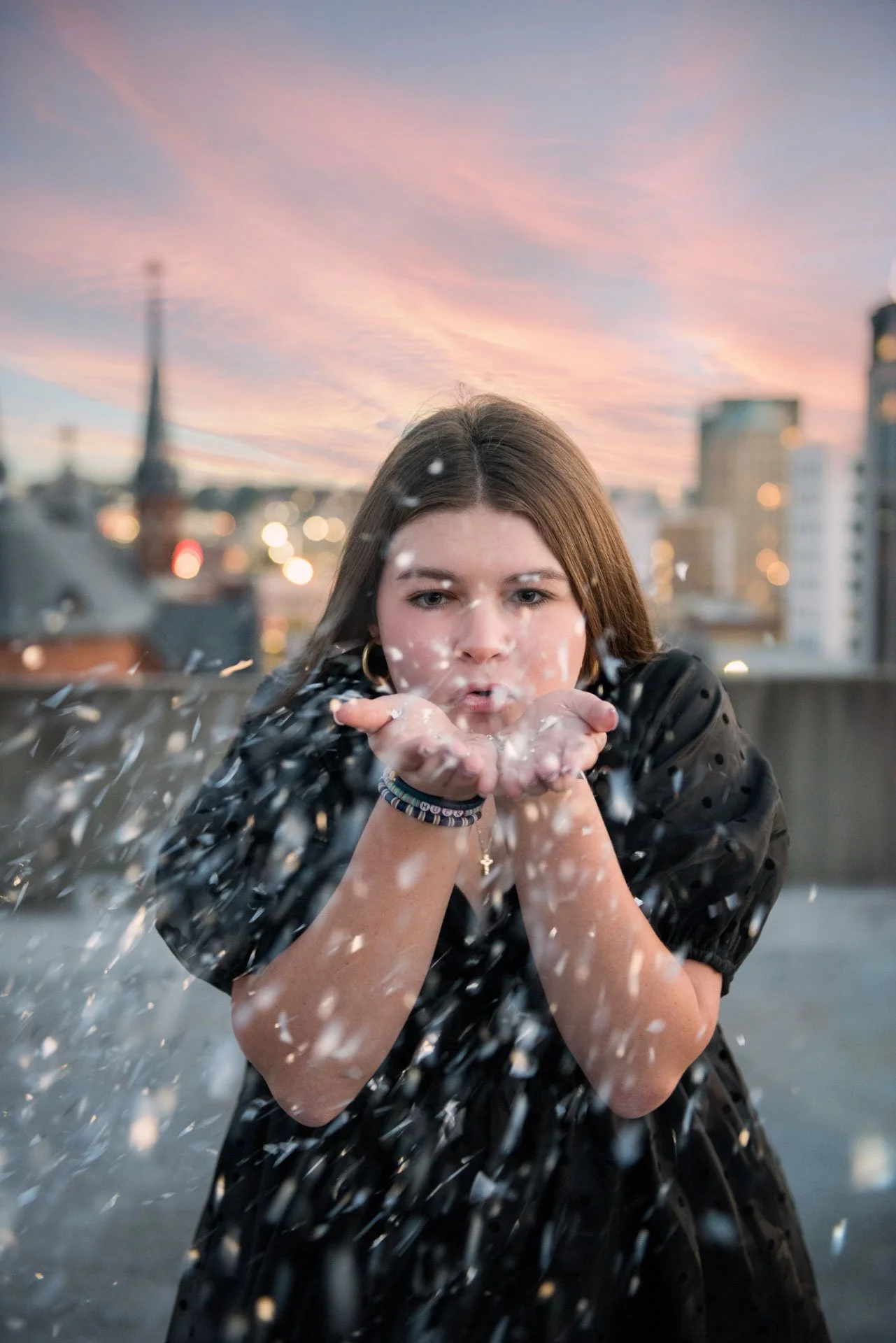 Senior girl blowing confetti on Birmingham Alabama rooftop at sunset, Darling Dear Photo