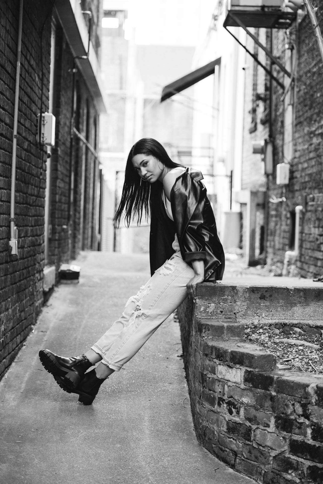 Low angle editorial portrait against brick building in Birmingham Alabama, Darling Dear Photo