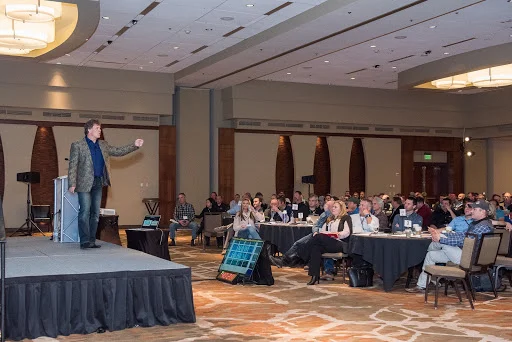 event speaker at user member conference on a stage.jpg