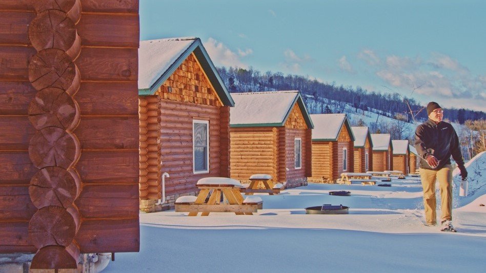 Snow-covered luxury cabins at Rippling River Resort in Marquette, Michigan