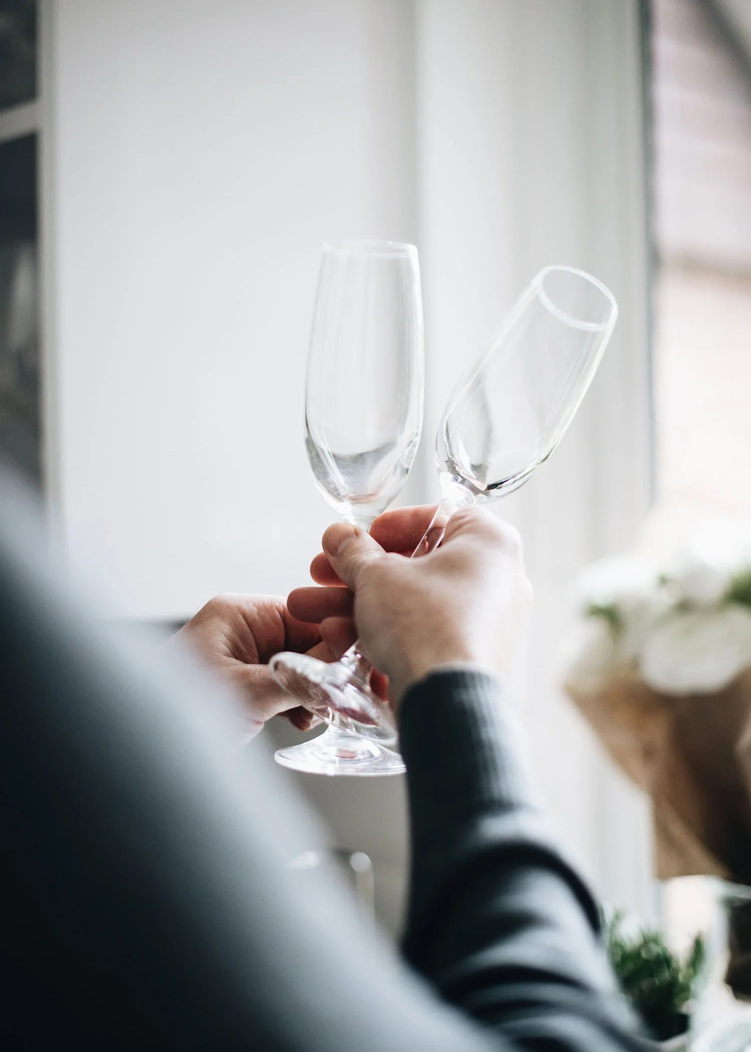 2-man-holding-two-champagne-flutes.jpg